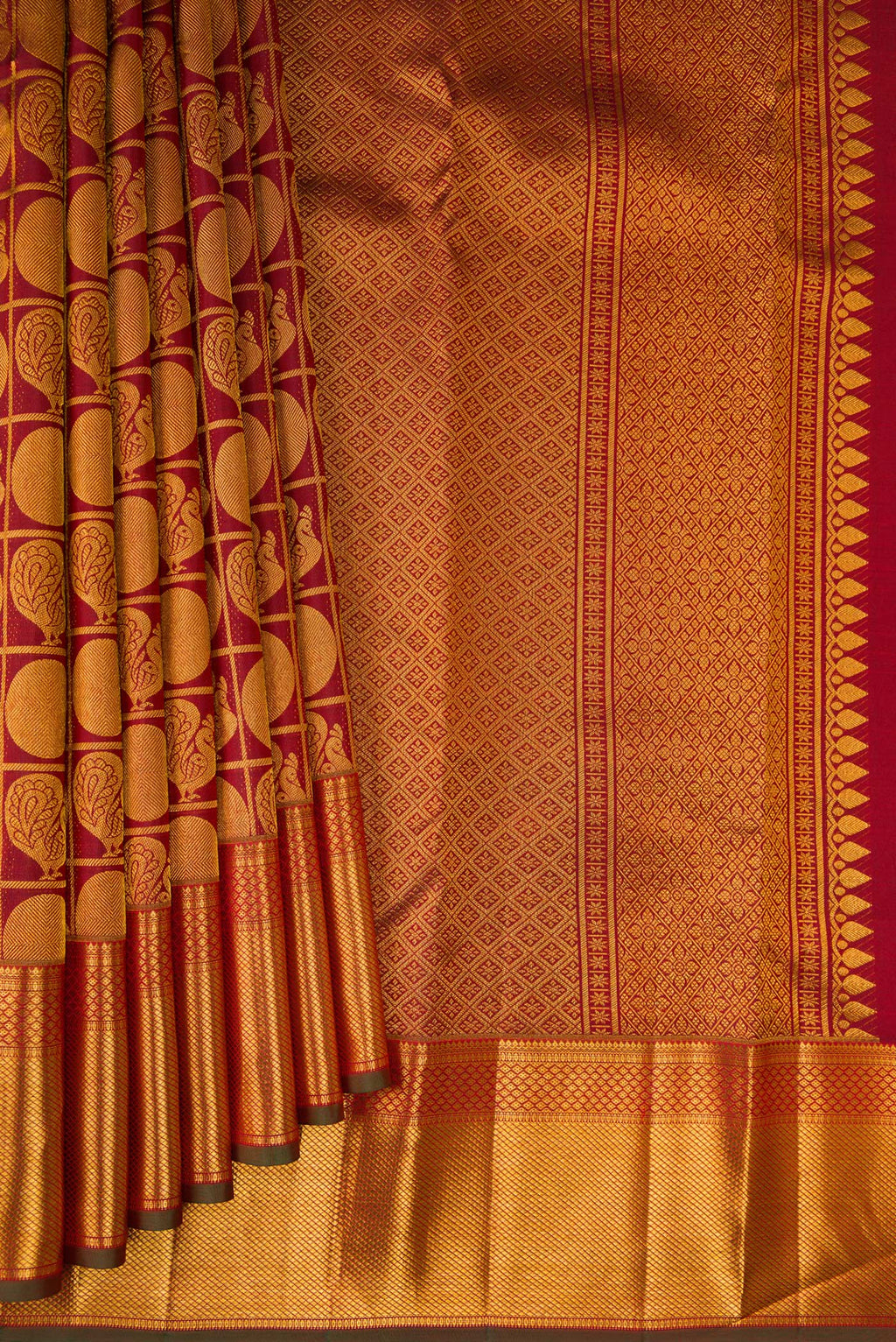 Pleats and pallu of Maroon Kanchipuram Silk Saree with Zari Brocade on the body and Zari Border. 