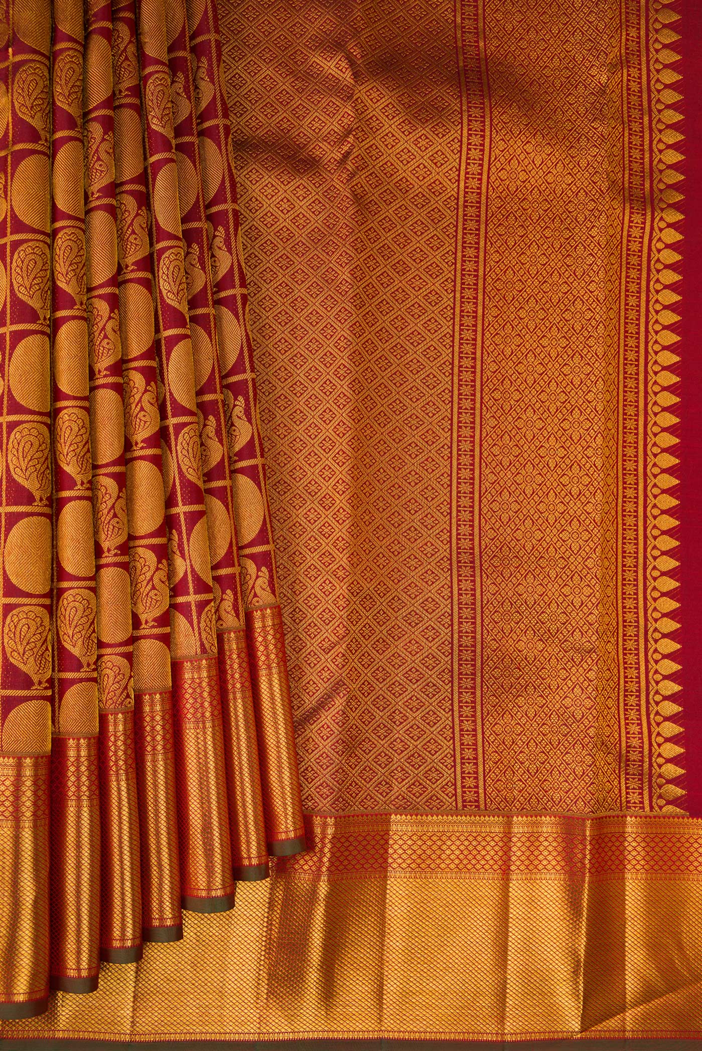 Pleats and pallu of Maroon Kanchipuram Silk Saree with Zari Brocade on the body and Zari Border. 