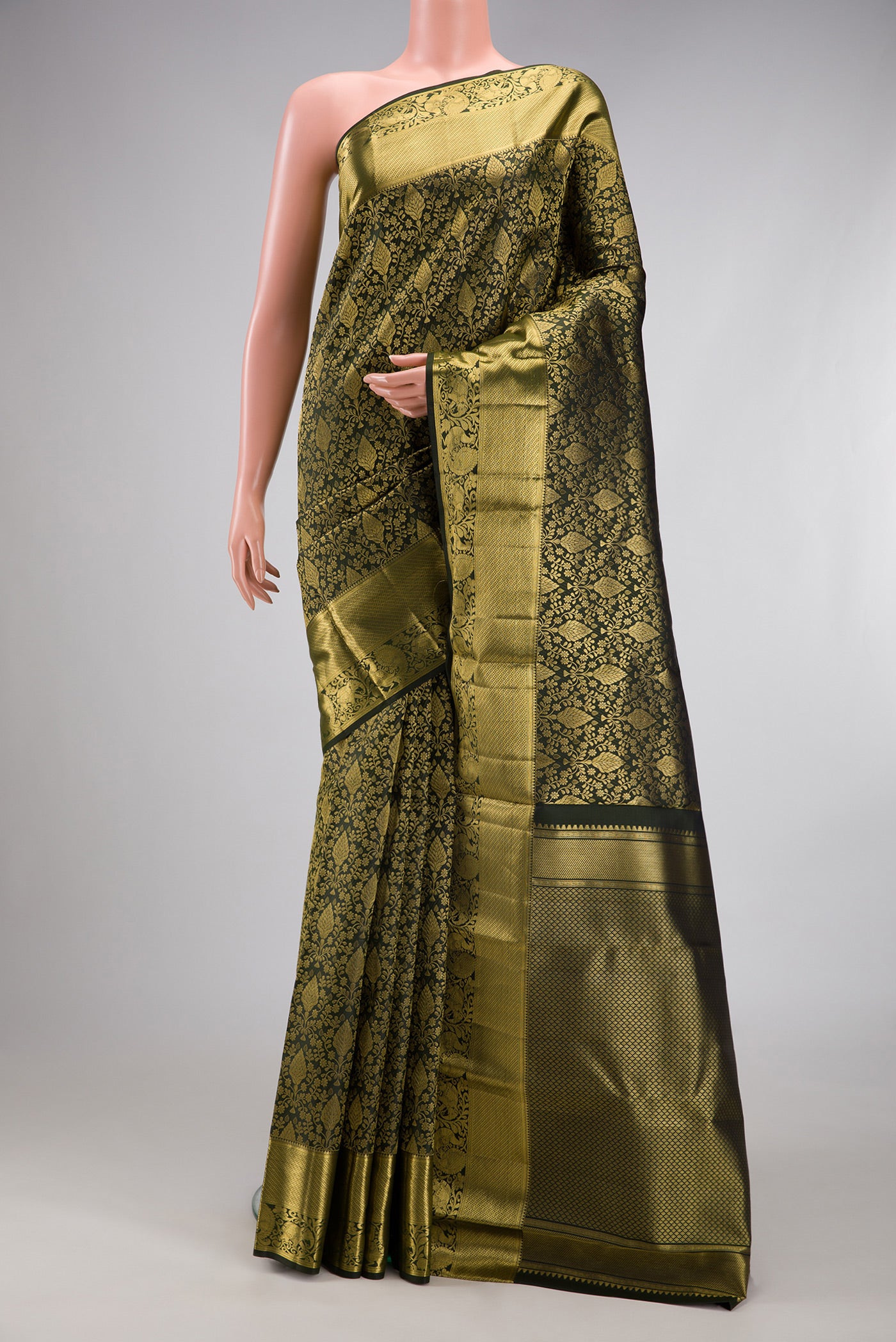 Bottle Green Kanchipuram Silk Saree with Zari Brocade on the body and Zari Border.  displayed on a mannequin