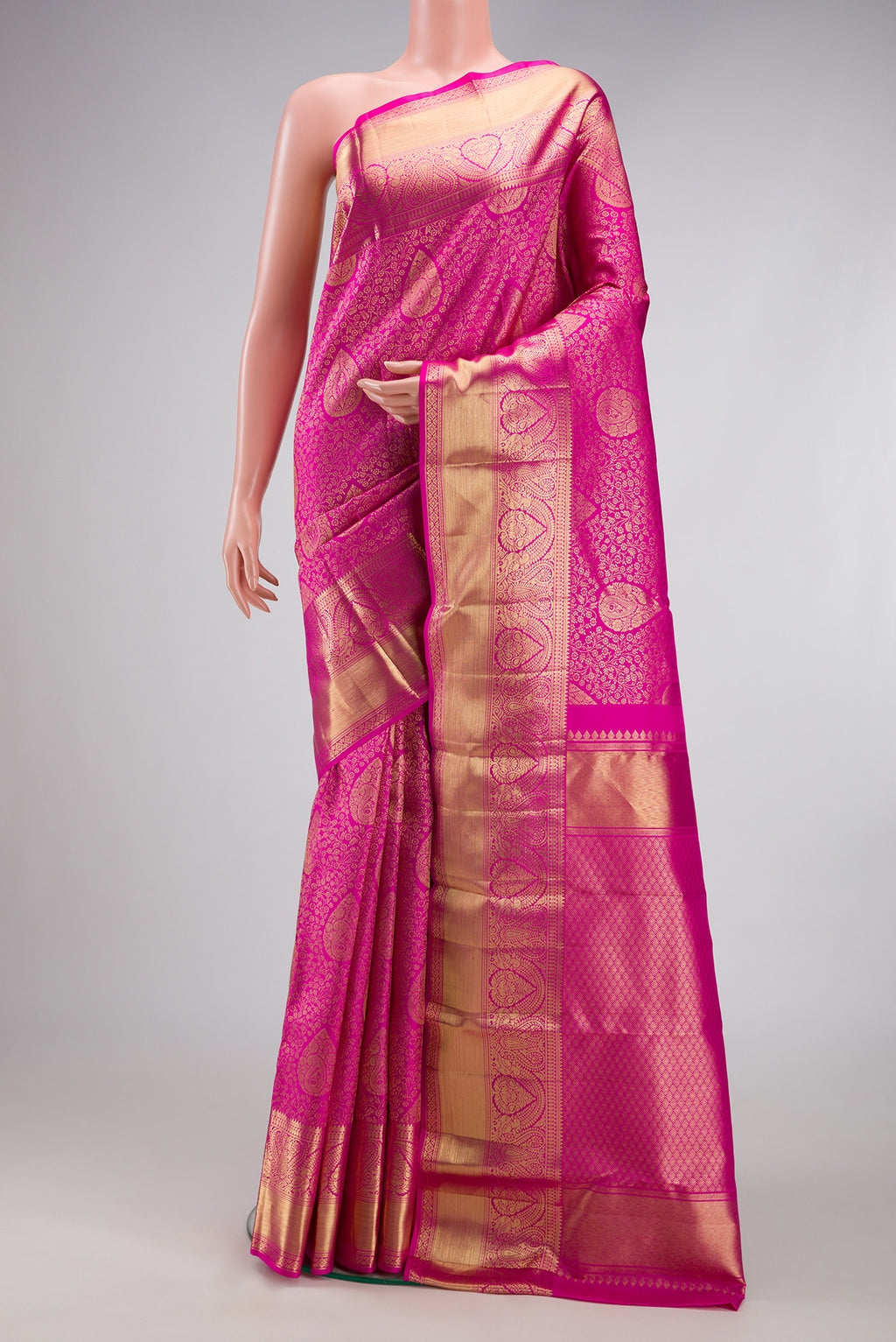 Rani Pink Kanchipuram Silk Saree with Zari Brocade on the body and Zari Border.  displayed on a mannequin