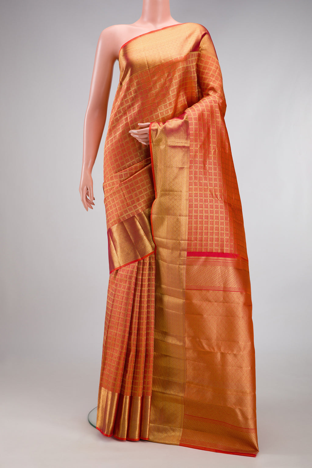 Orange Kanchipuram Silk Saree with Zari Brocade on the body and Zari Border.  displayed on a mannequin