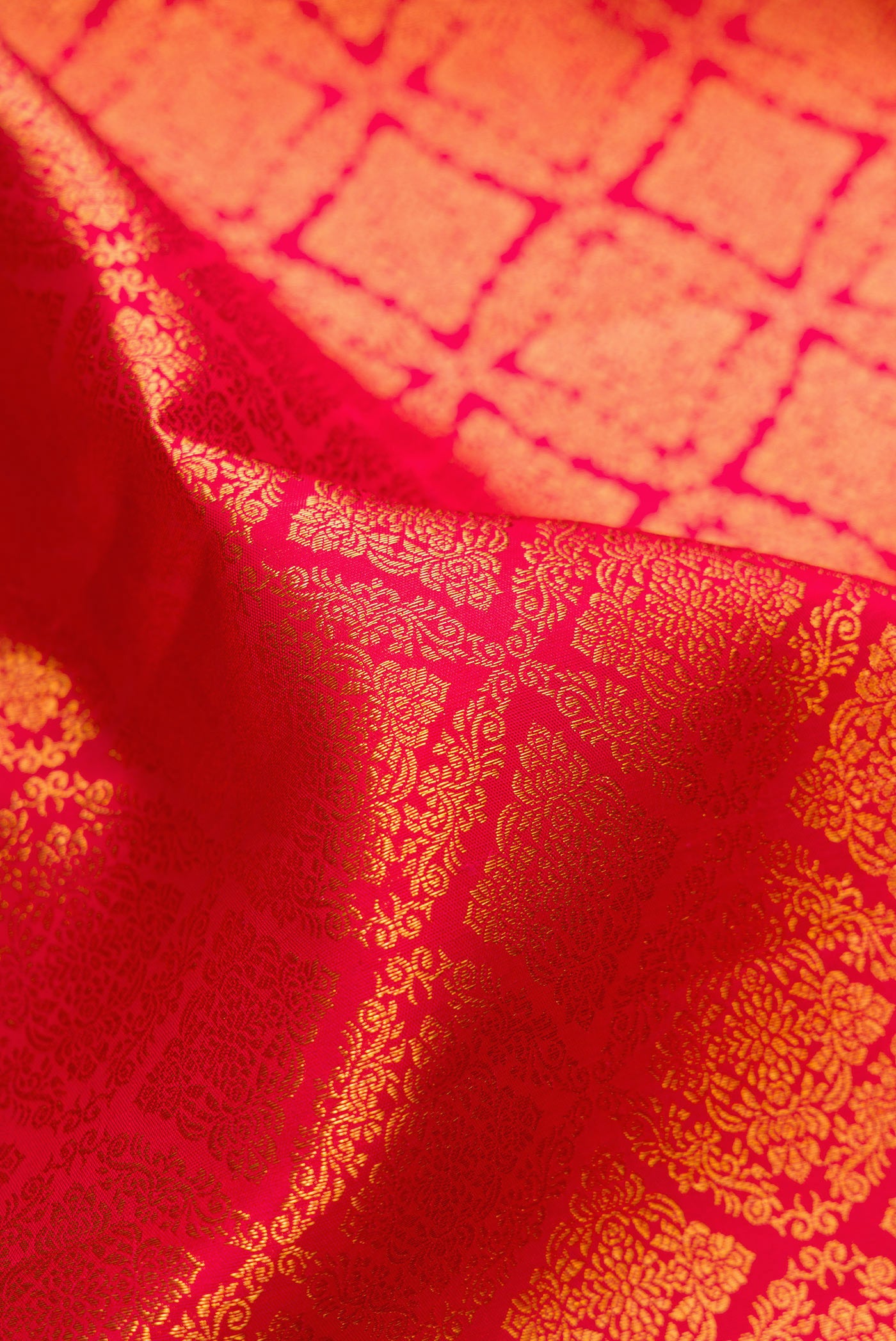 Close up of Red Kanchipuram Silk Saree with Zari Brocade on the body and Zari Border.  displaying folds
