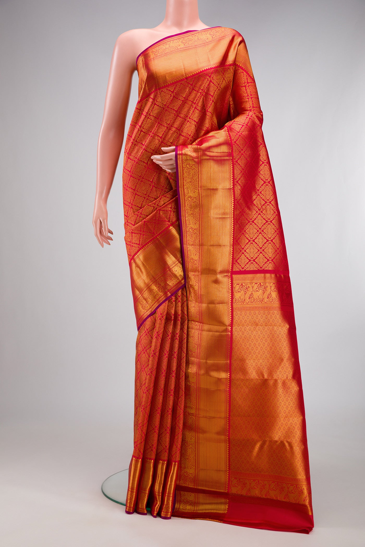 Red Kanchipuram Silk Saree with Zari Brocade on the body and Zari Border.  displayed on a mannequin