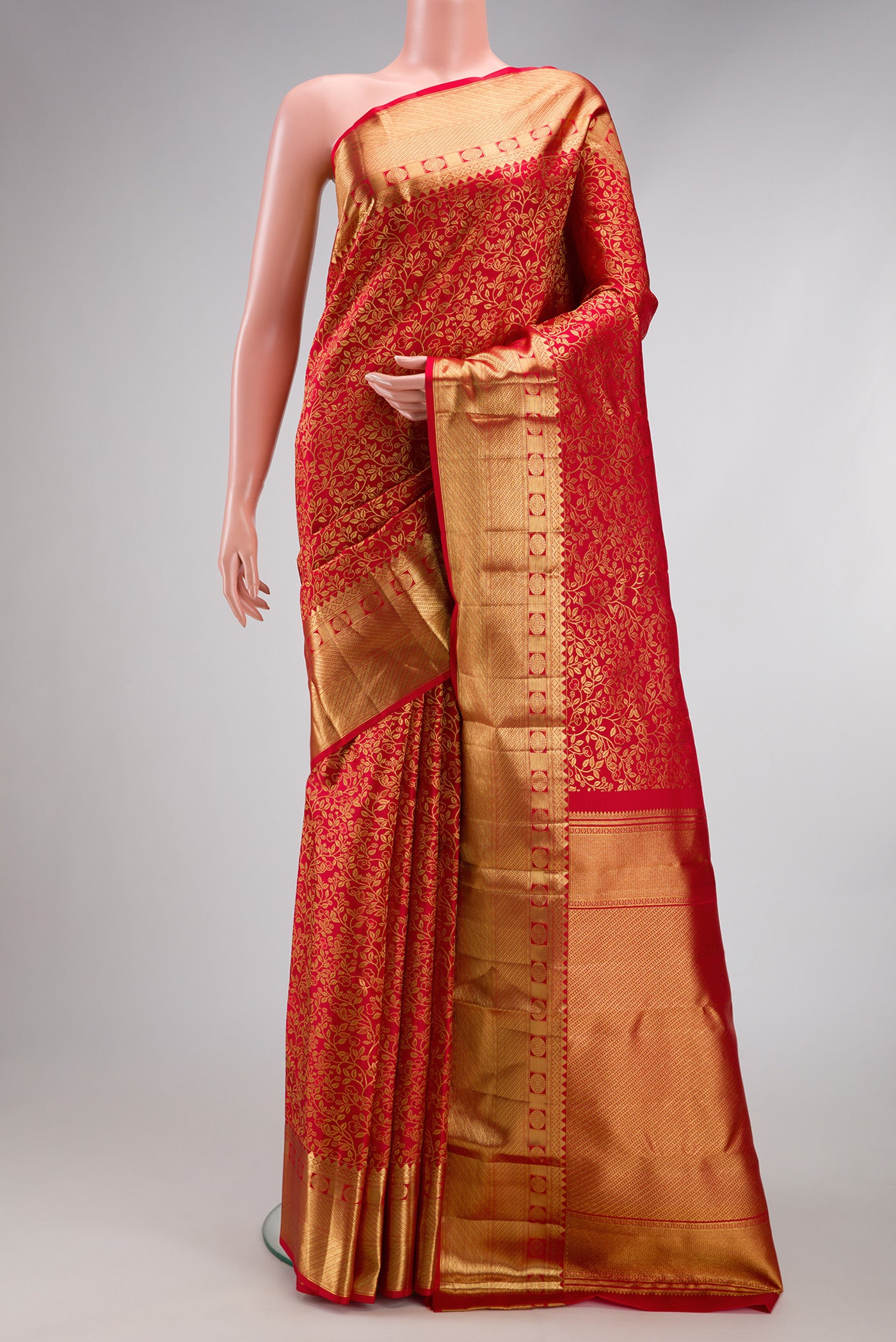 Red Kanchipuram Silk Saree with Zari Brocade on the body and Zari Border.  displayed on a mannequin