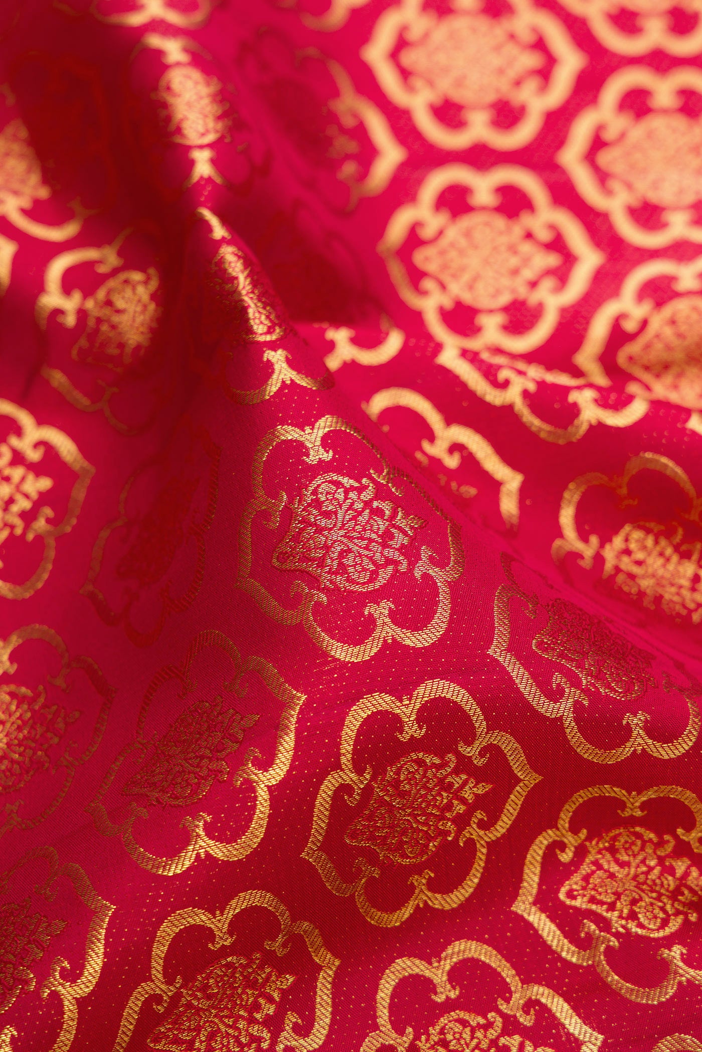 Close up of Maroon Kanchipuram Silk Saree with Zari Brocade on the body and Zari Border.  displaying folds