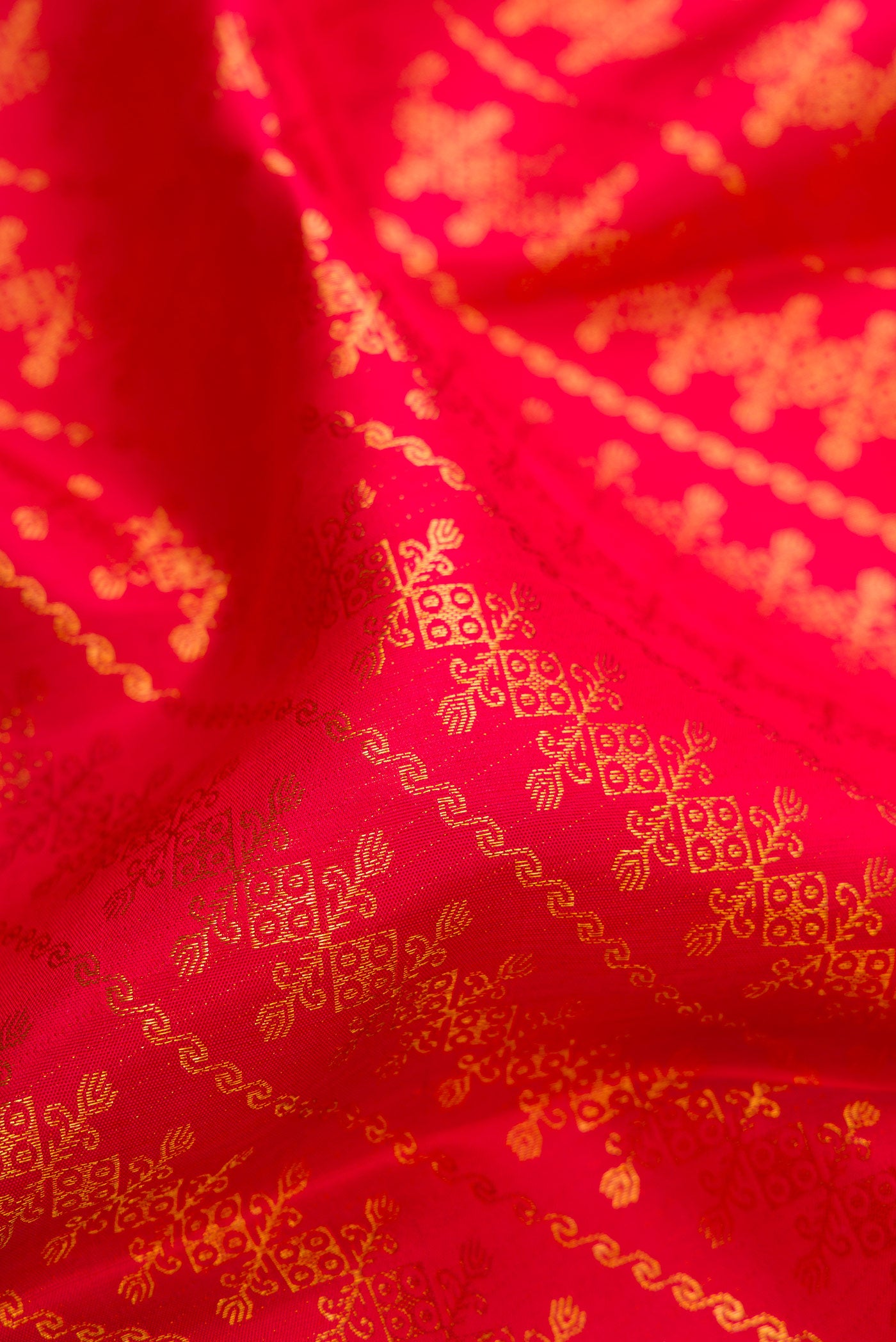 Close up of Red Kanchipuram Silk Saree with Zari Brocade on the body and Zari Border.  displaying folds