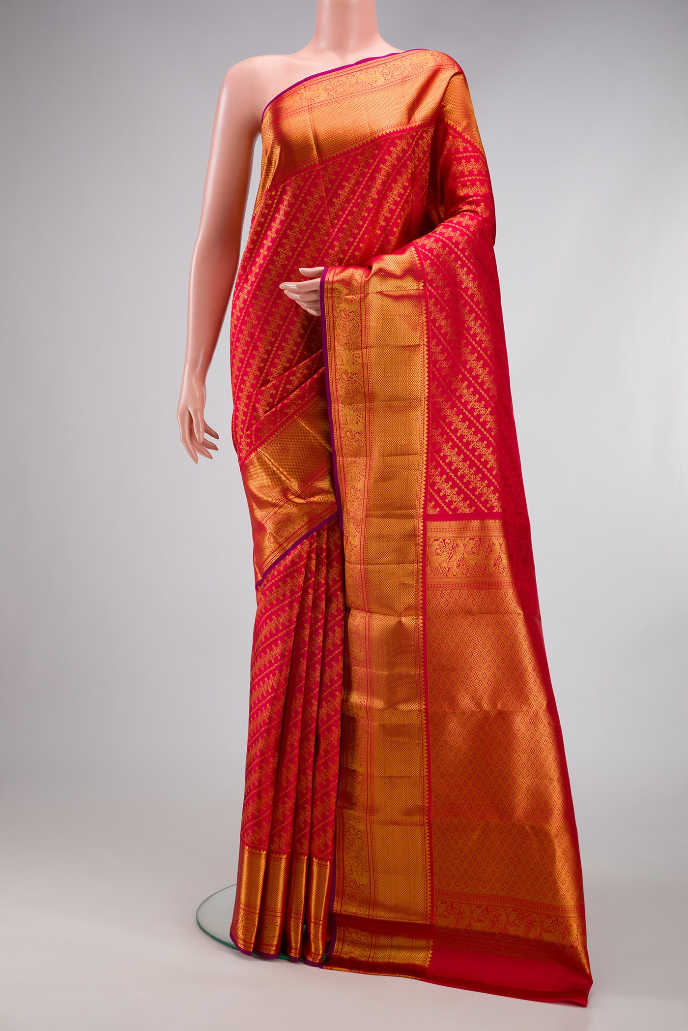 Red Kanchipuram Silk Saree with Zari Brocade on the body and Zari Border.  displayed on a mannequin