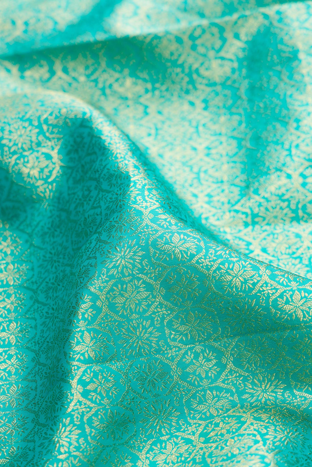 Close up of Sky Blue Kanchipuram Silk Saree with Zari Brocade on the body and Zari Border.  displaying folds