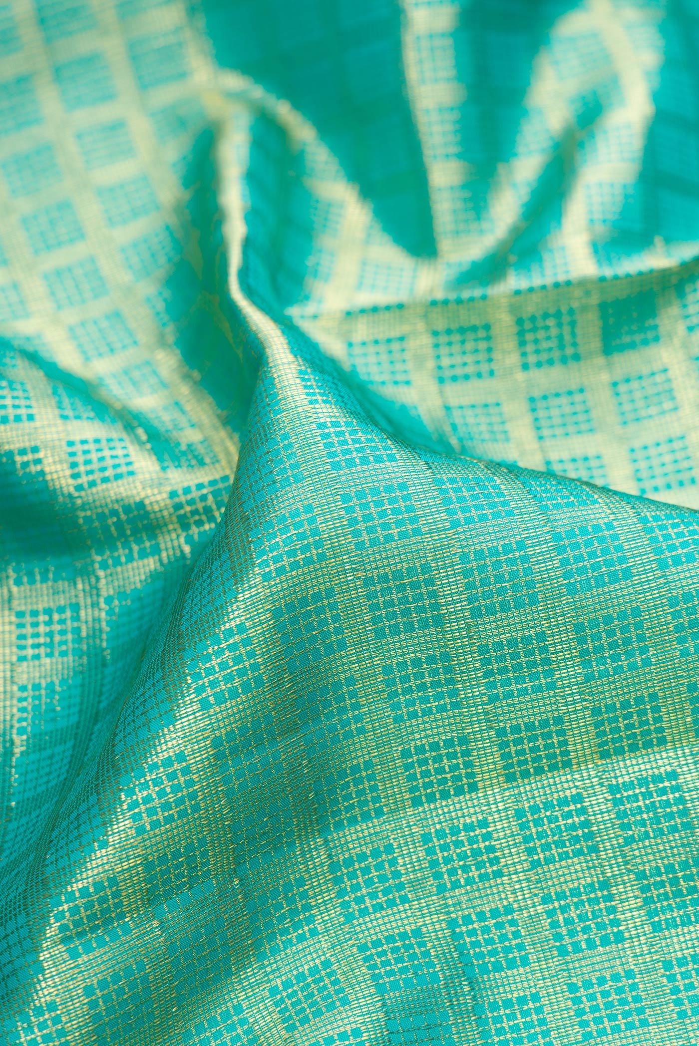 Close up of Sky Blue Kanchipuram Silk Saree with Zari Brocade on the body and Zari Border.  displaying folds