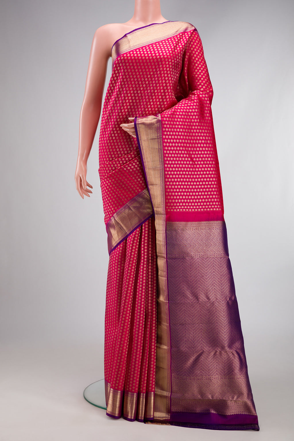 Dark Pink Kanchipuram Silk Saree with Zari Brocade on the body and Zari Border.  displayed on a mannequin