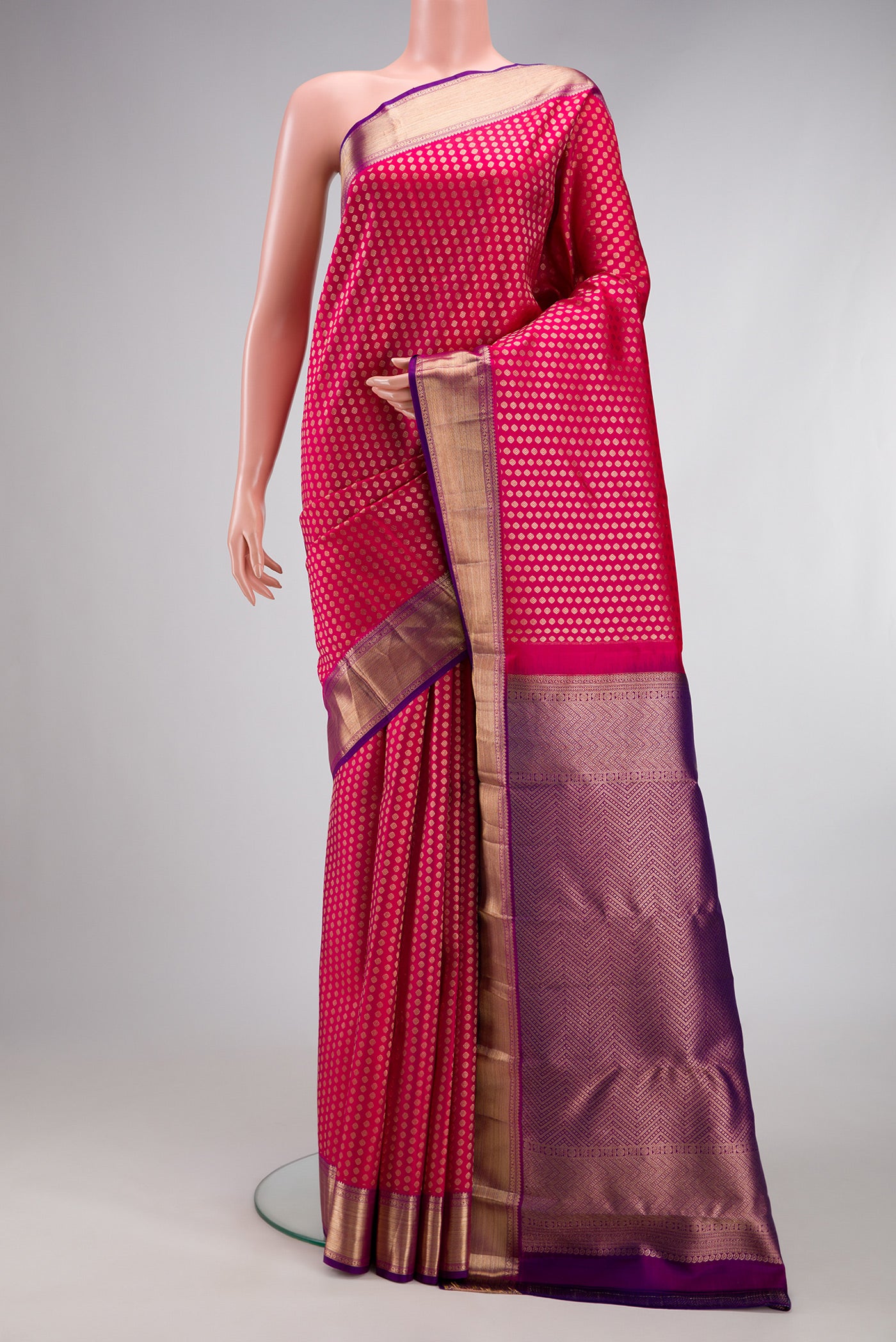 Dark Pink Kanchipuram Silk Saree with Zari Brocade on the body and Zari Border.  displayed on a mannequin