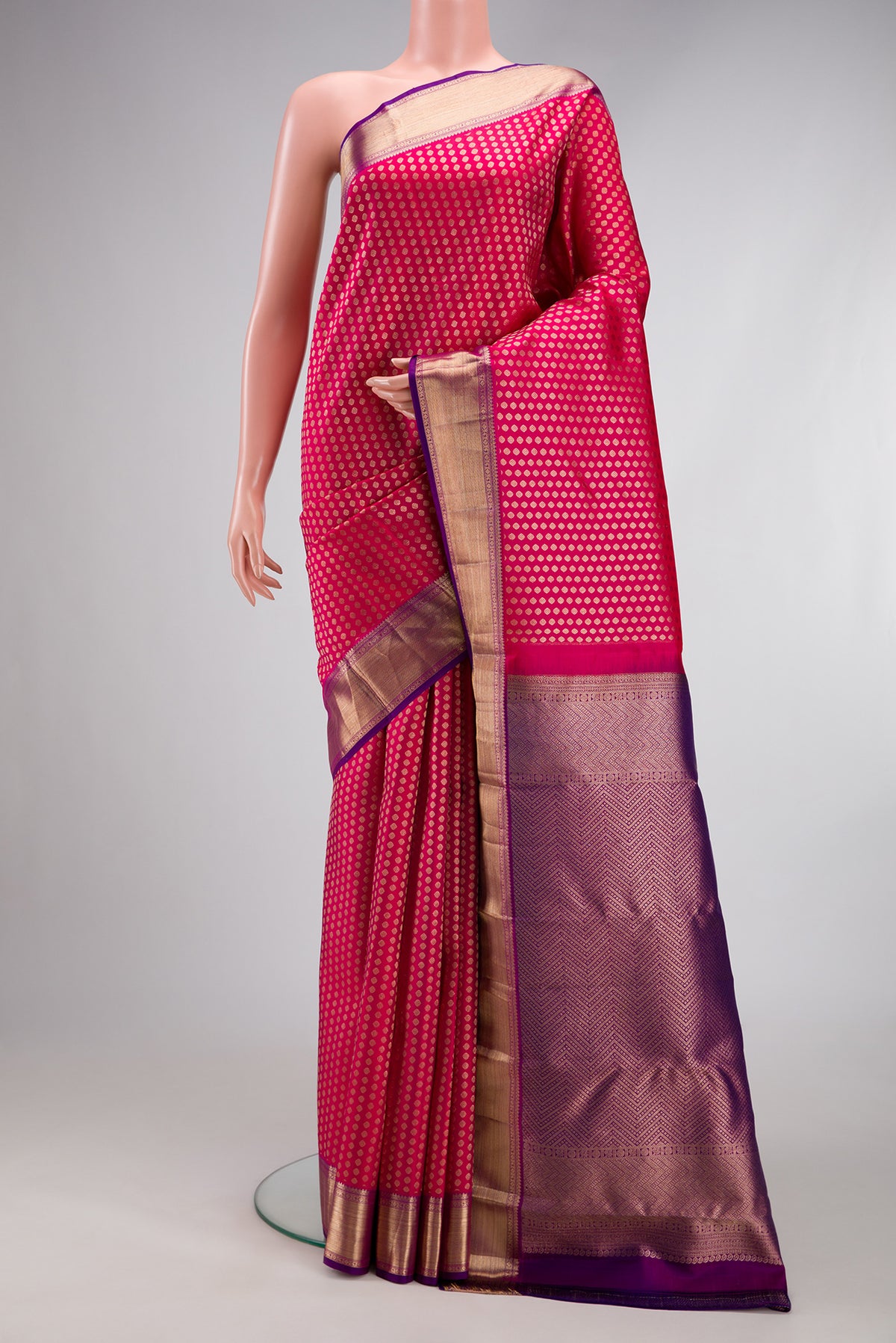 Dark Pink Kanchipuram Silk Saree with Zari Brocade on the body and Zari Border.  displayed on a mannequin