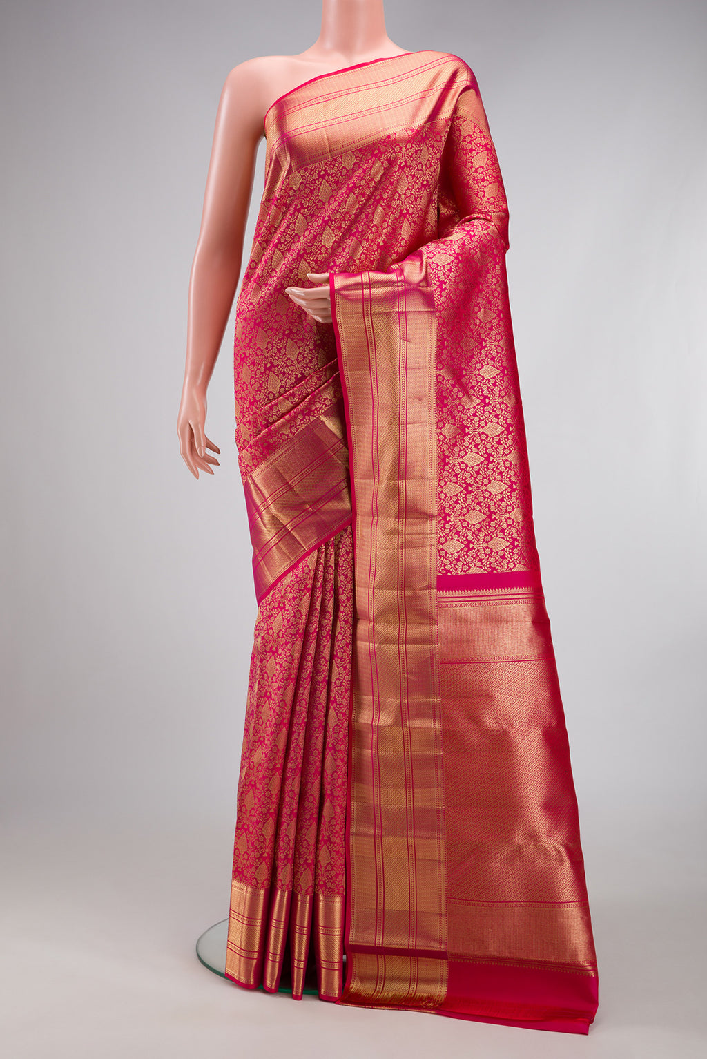 Dark Pink Kanchipuram Silk Saree with Zari Brocade on the body and Zari Border.  displayed on a mannequin