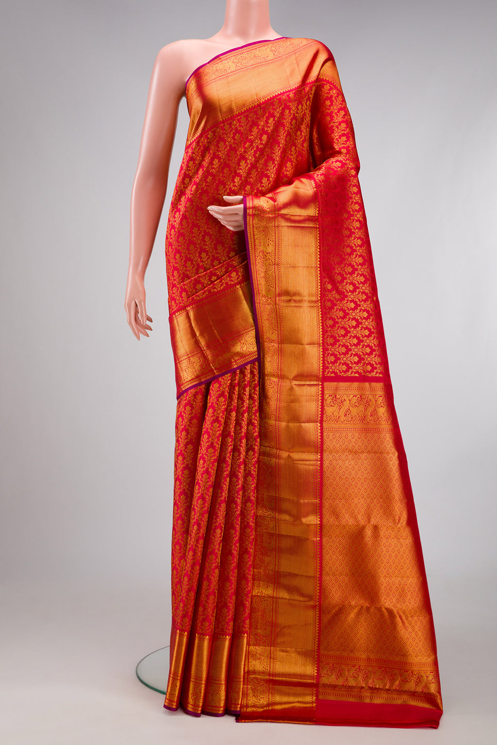 Red Kanchipuram Silk Saree with Zari Brocade on the body and Zari Border.  displayed on a mannequin