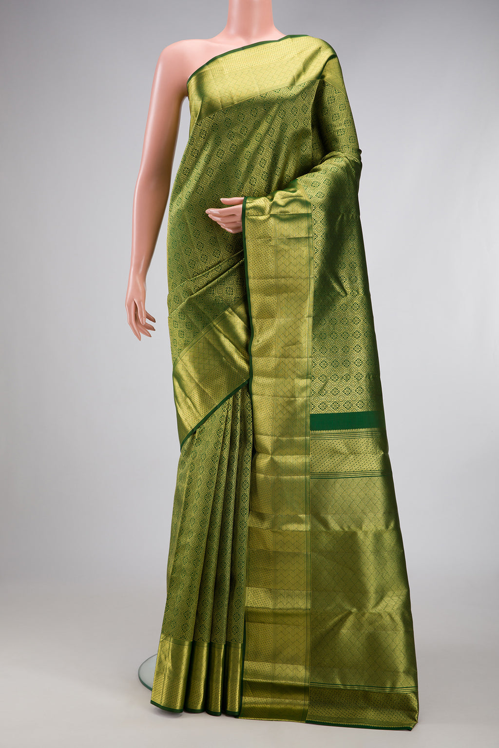 Bottle Green Kanchipuram Silk Saree with Zari Brocade on the body and Zari Border.  displayed on a mannequin