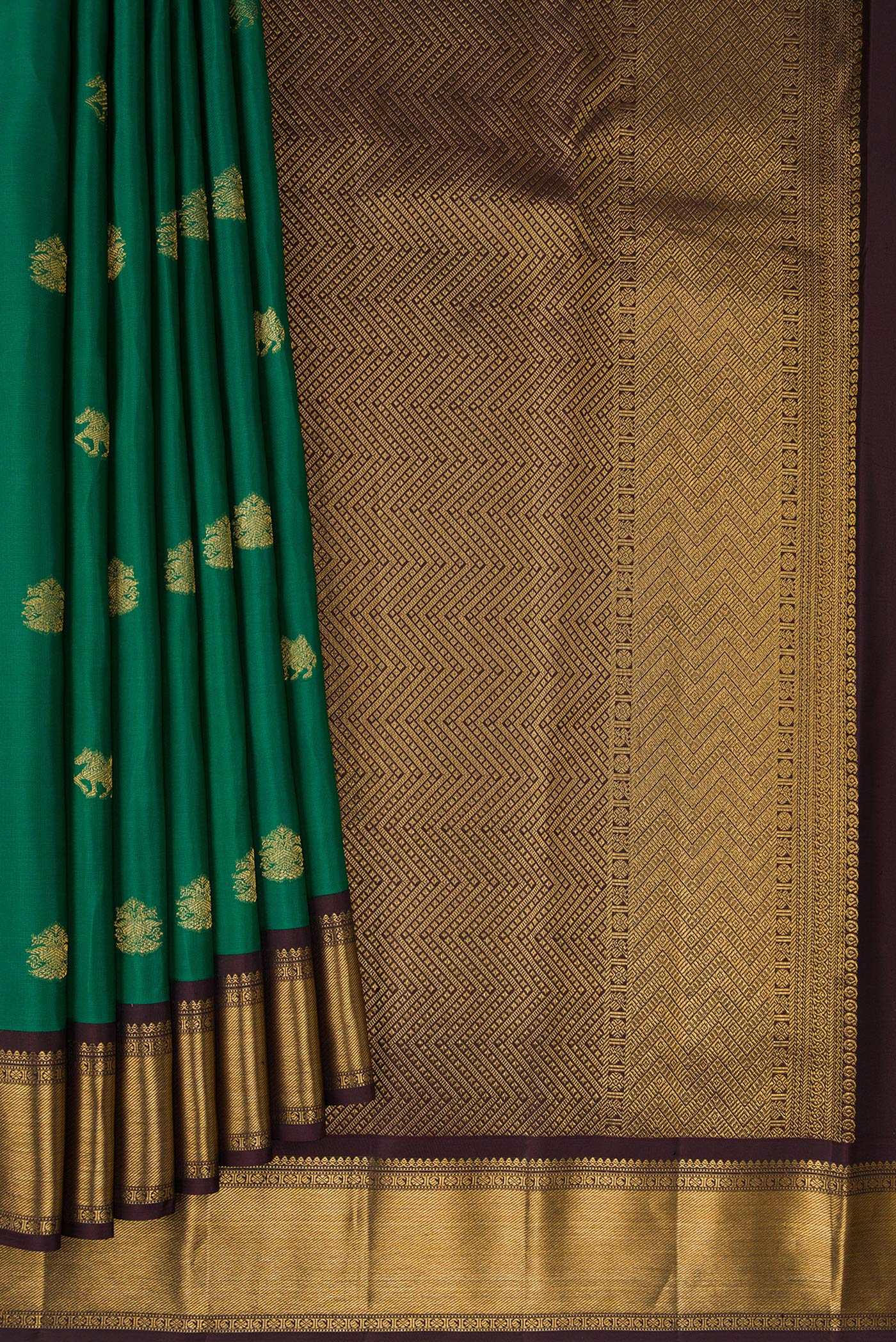Pleats and pallu of Green Kanjivaram Silk Saree with Zari Butta on the body and Zari Border. 