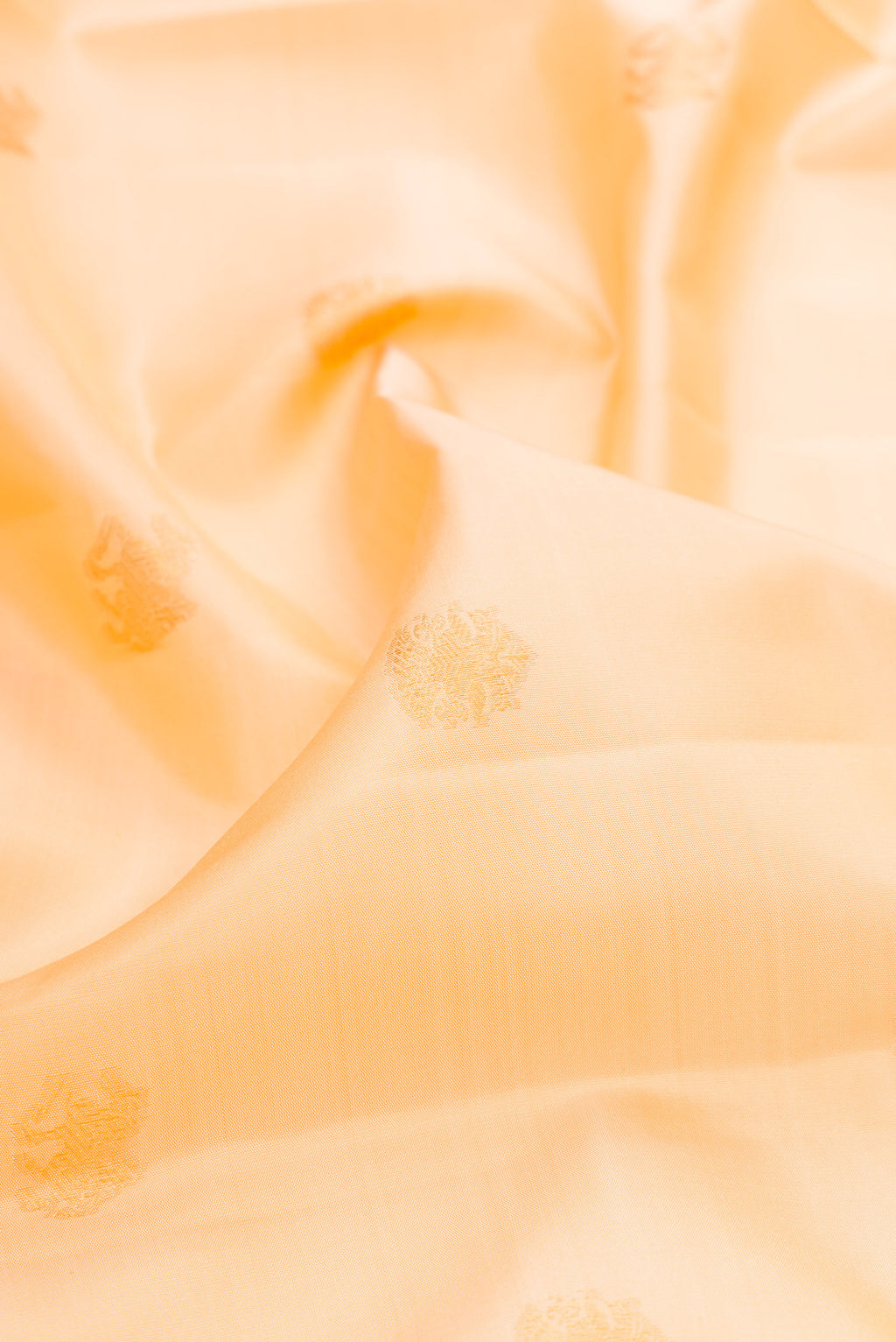 Close up of Sandal Kanjivaram Silk Saree with Zari Butta on the body and Zari Border.  displaying folds