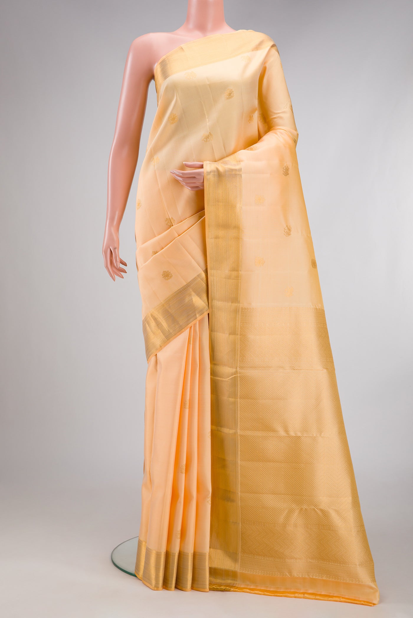 Sandal Kanjivaram Silk Saree with Zari Butta on the body and Zari Border.  displayed on a mannequin
