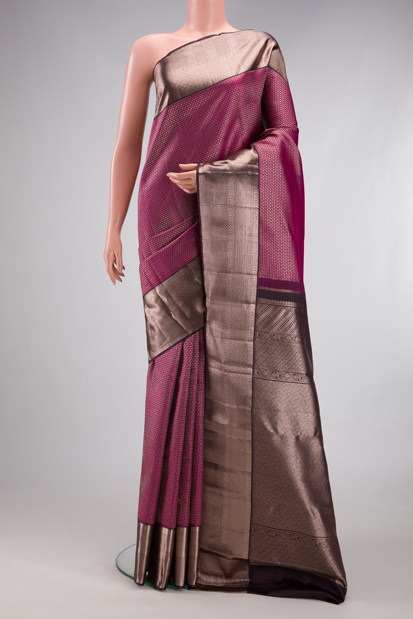 Magenta Kanchipuram Silk Saree with Zari Brocade on the body and Zari Border.  displayed on a mannequin