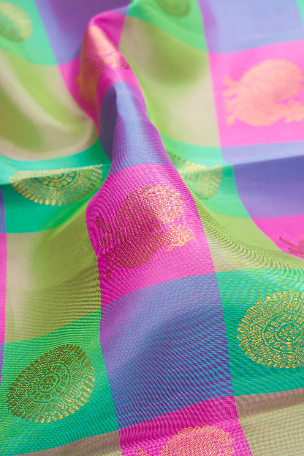 Close up of Multi Color Kanchipuram Silk Saree with Checked design on the body and Zari Border.  displaying folds