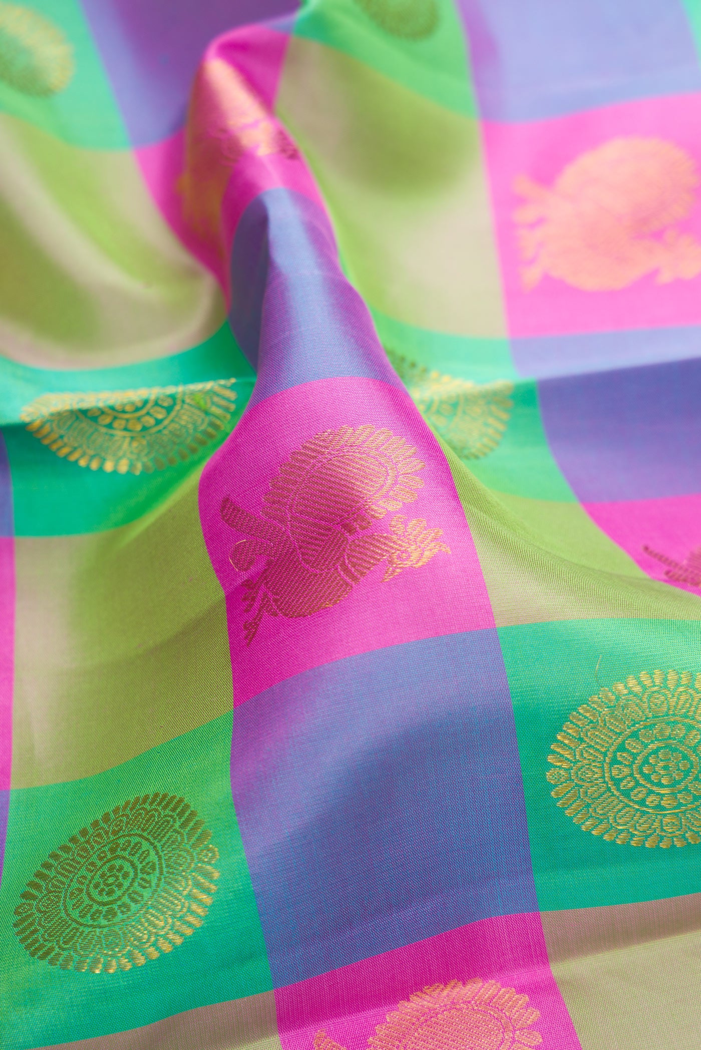Close up of Multi Color Kanchipuram Silk Saree with Checked design on the body and Zari Border.  displaying folds