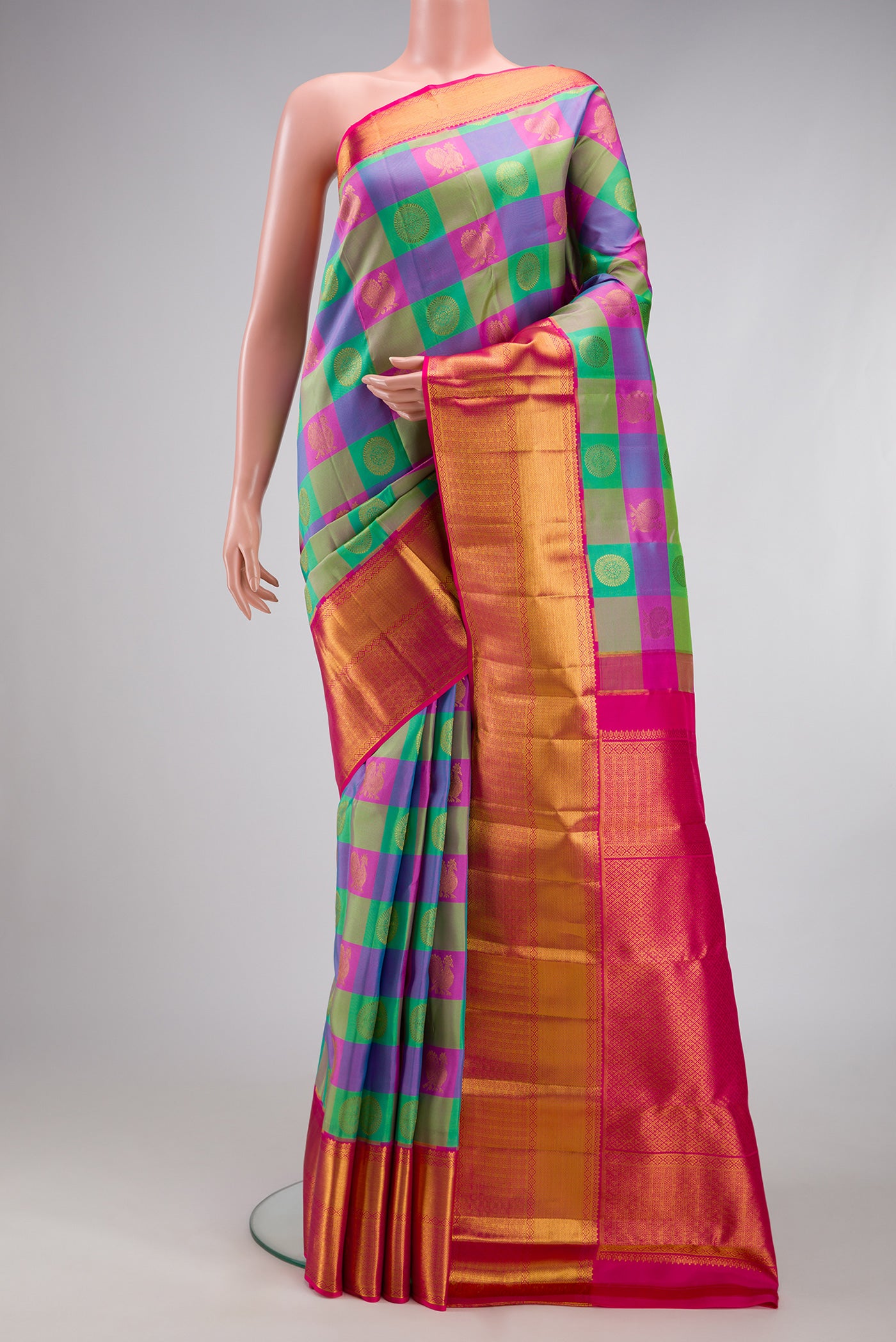 Multi Color Kanchipuram Silk Saree with Checked design on the body and Zari Border.  displayed on a mannequin
