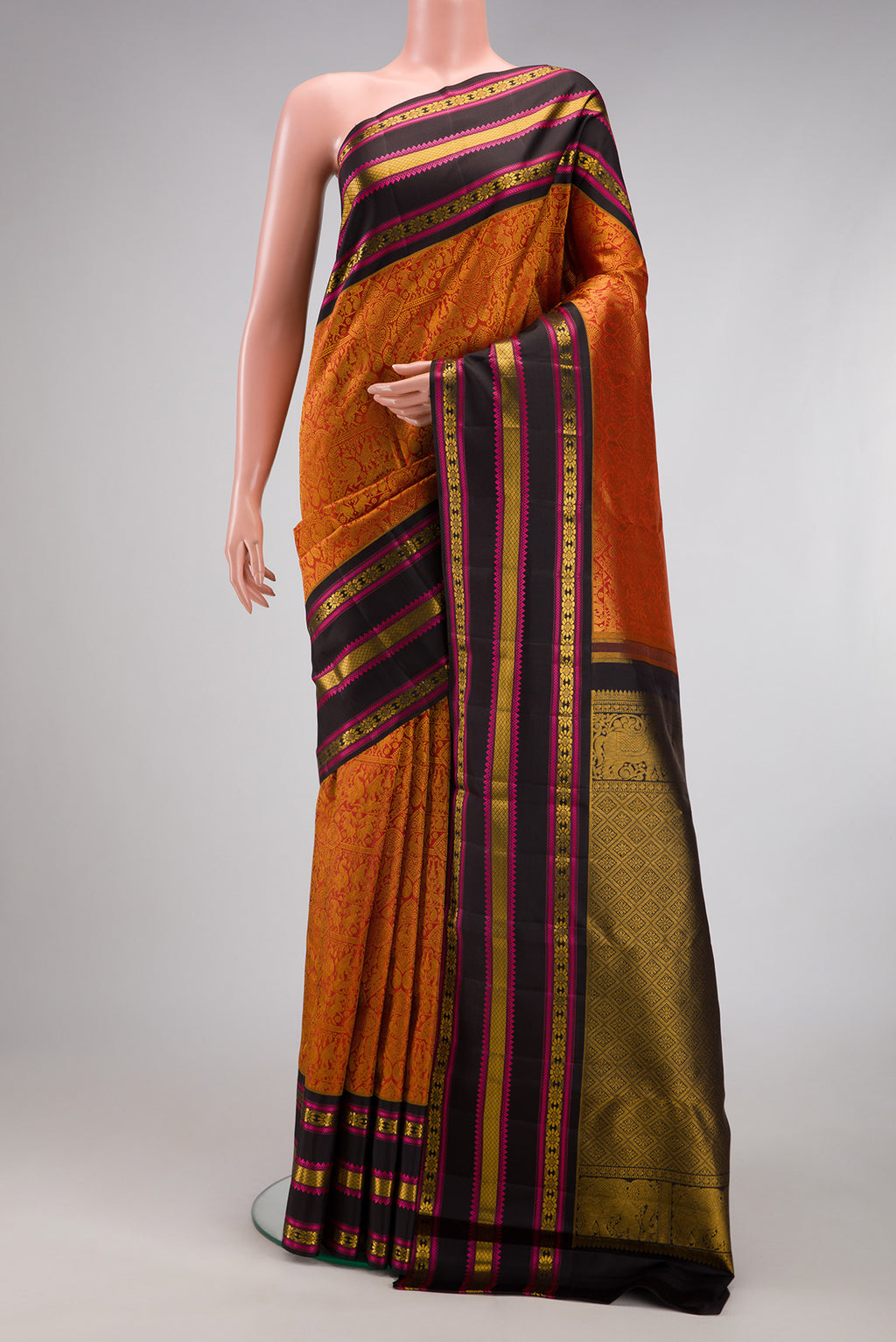 Brick Orange Dual Tone Kanchipuram Silk Saree with Zari Brocade on the body and Zari And Thread Border.  displayed on a mannequin