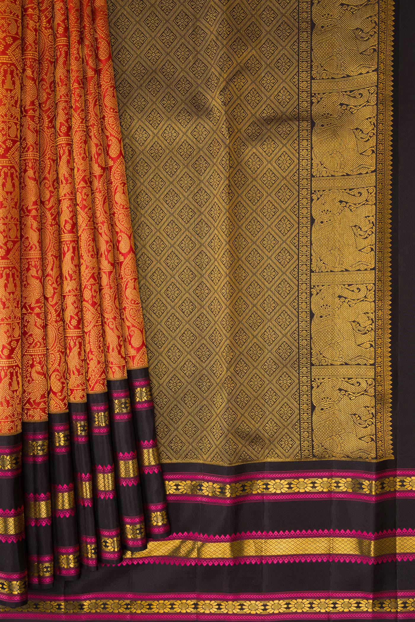 Pleats and pallu of Brick Orange Dual Tone Kanchipuram Silk Saree with Zari Brocade on the body and Zari And Thread Border. 