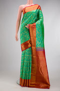 Green Kanchipuram Silk Saree with Zari Brocade on the body and Zari Border.  displayed on a mannequin