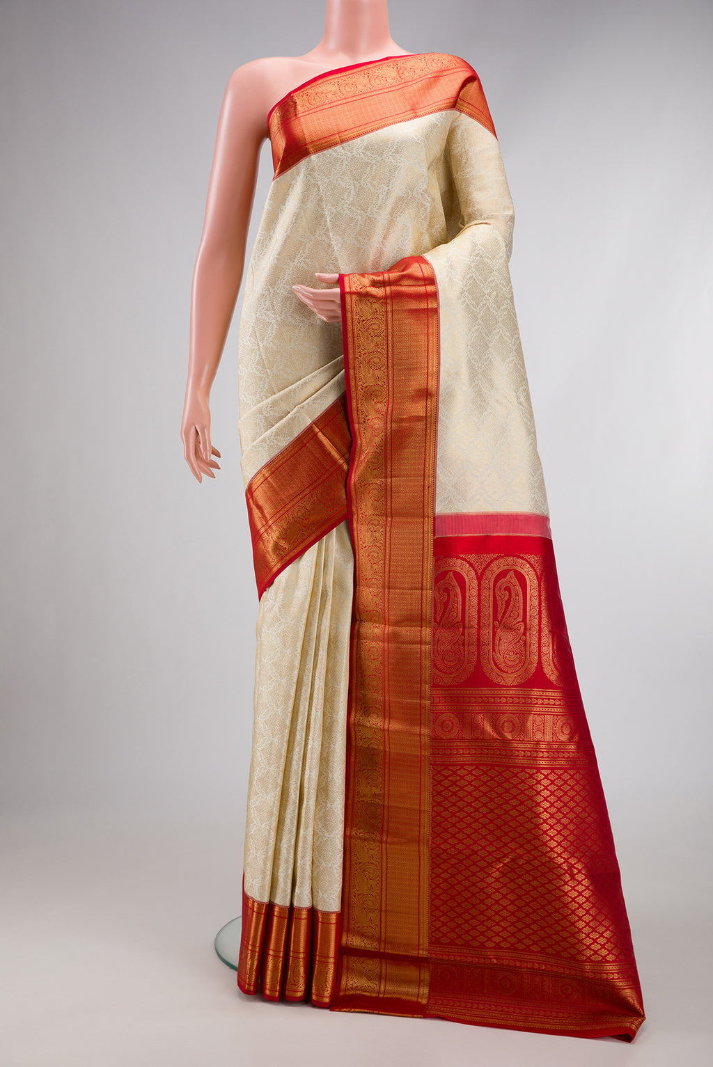 Off White Kanchipuram Silk Saree with Zari Brocade on the body and Zari Border.  displayed on a mannequin