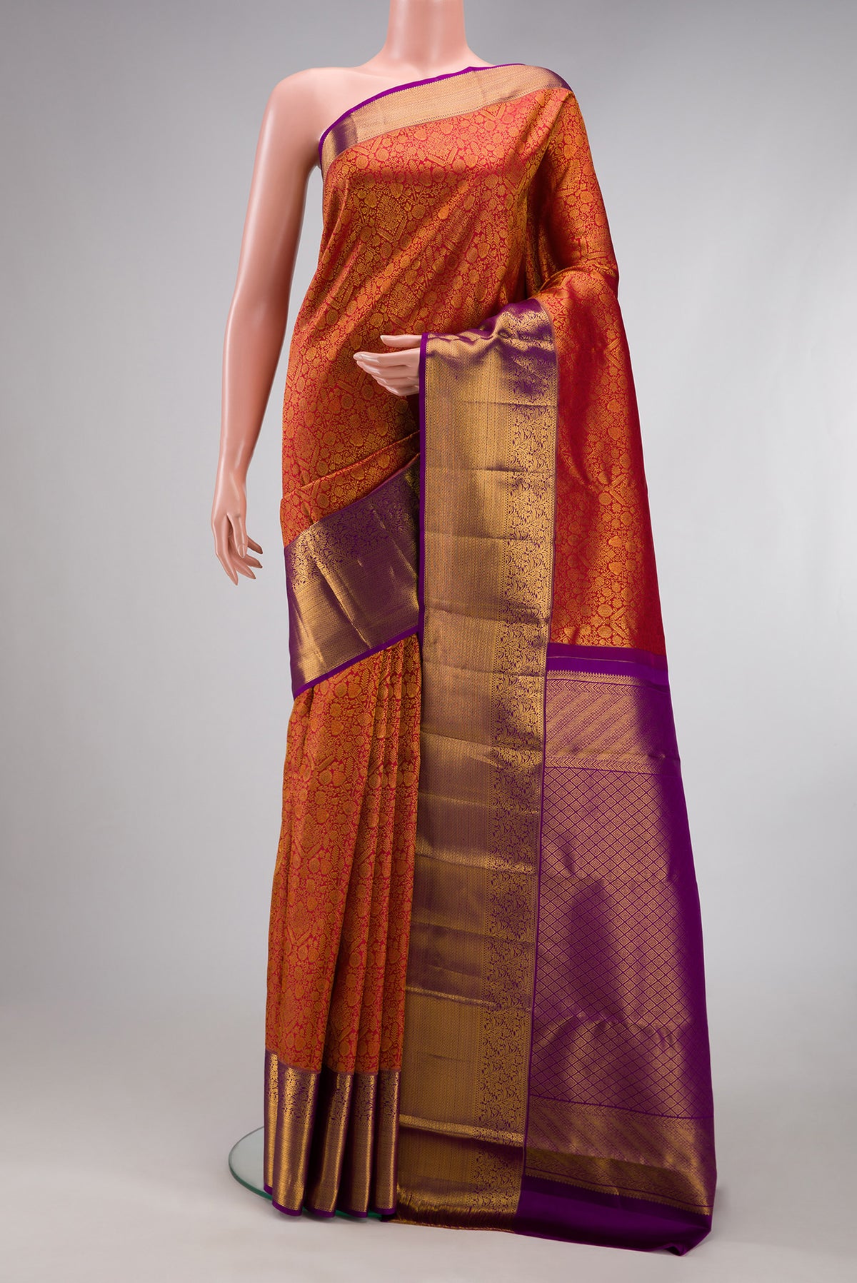 Brick Orange Kanchipuram Silk Saree with Zari Brocade on the body and Zari Border.  displayed on a mannequin
