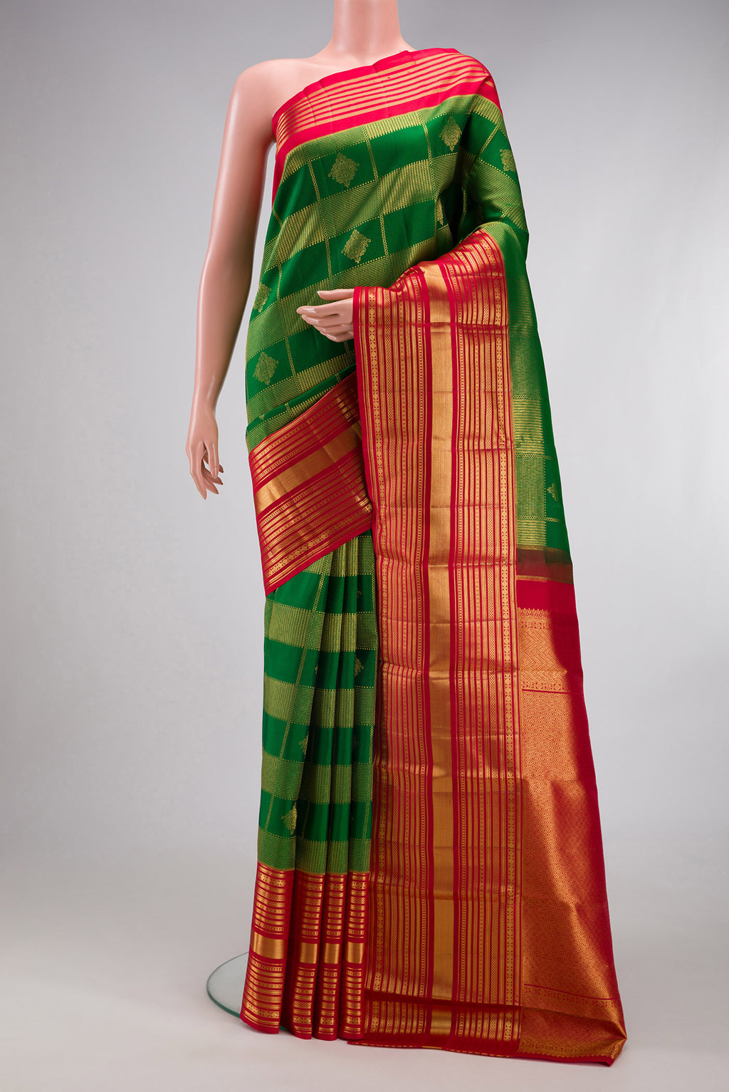 Green Kanchipuram Silk Saree with Zari Brocade on the body and Zari Border.  displayed on a mannequin