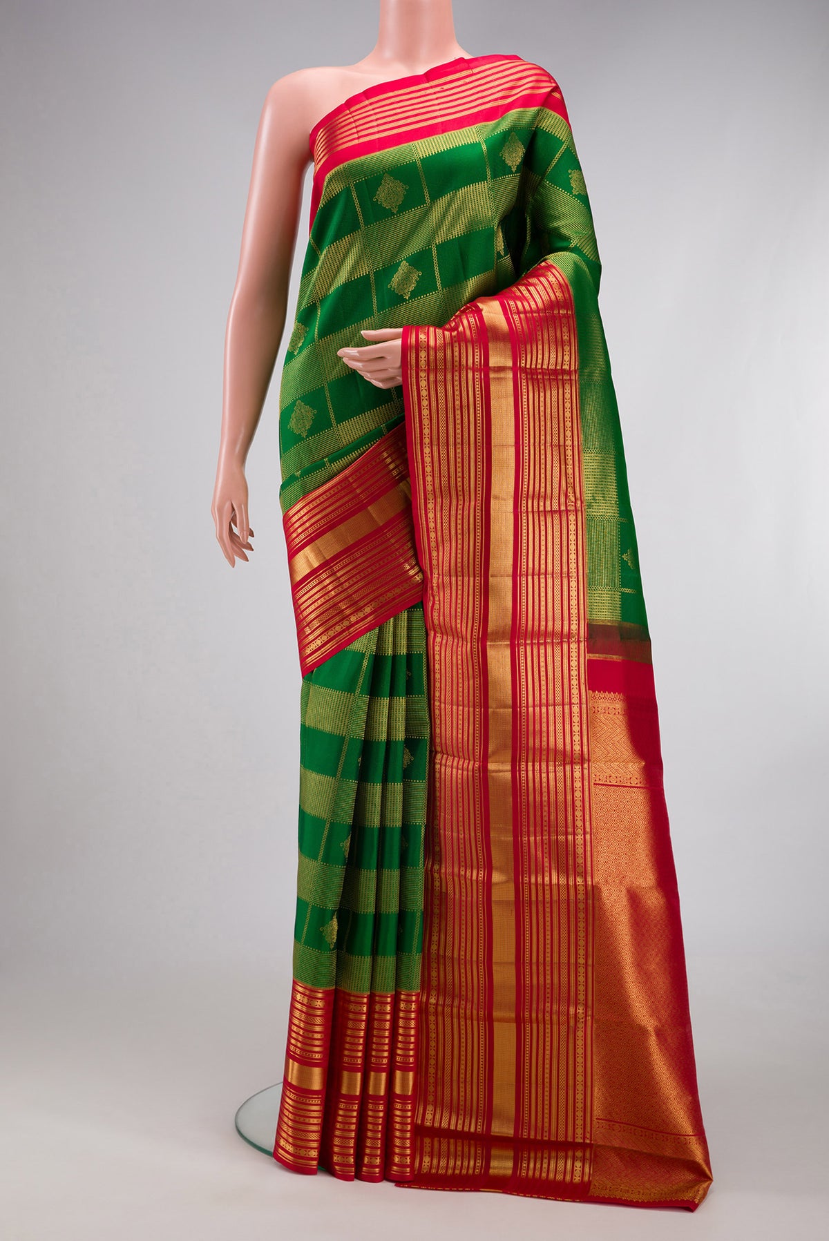 Green Kanchipuram Silk Saree with Zari Brocade on the body and Zari Border.  displayed on a mannequin