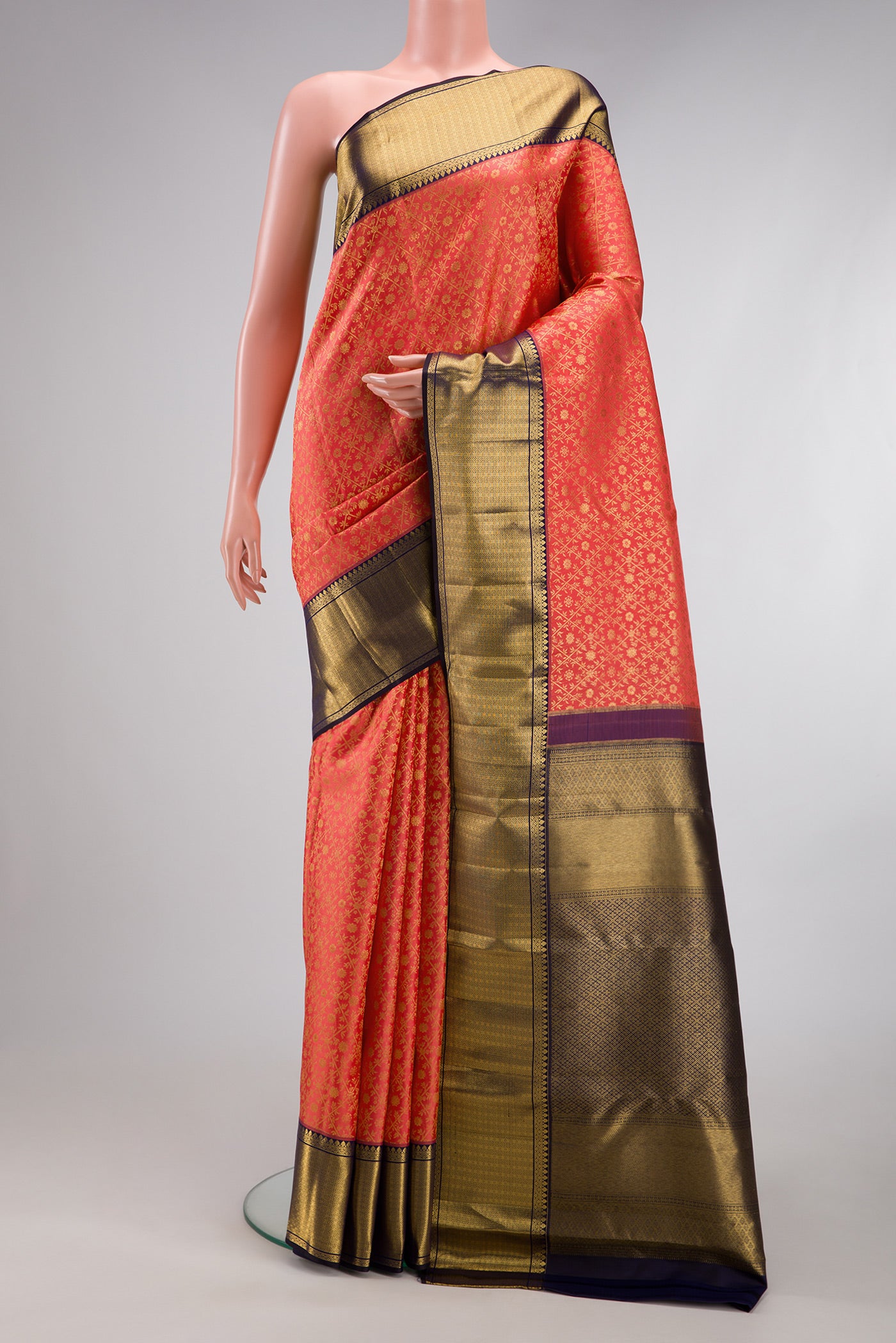Coral Kanchipuram Silk Saree with Zari Brocade on the body and Zari Border.  displayed on a mannequin