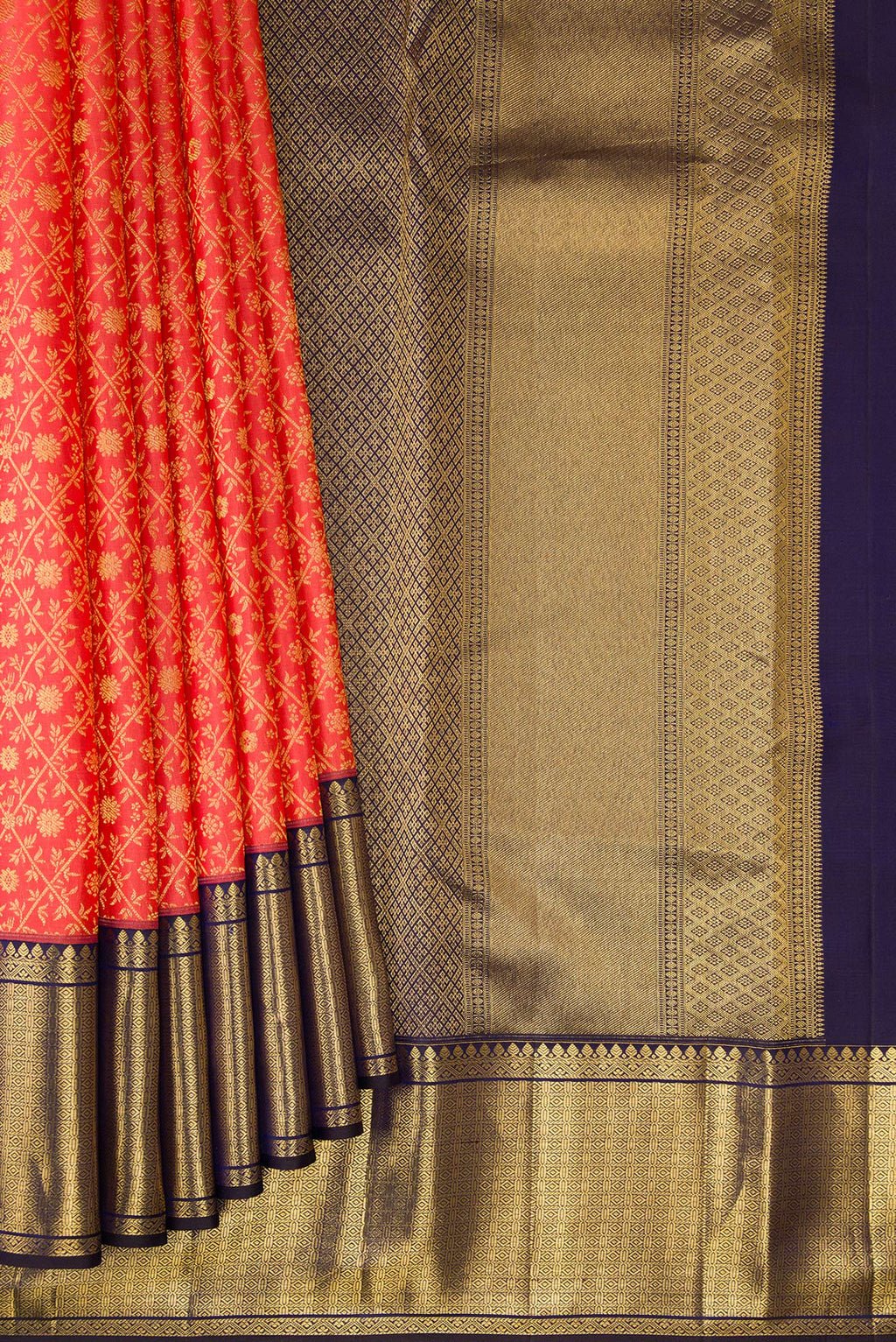 Pleats and pallu of Coral Kanchipuram Silk Saree with Zari Brocade on the body and Zari Border. 