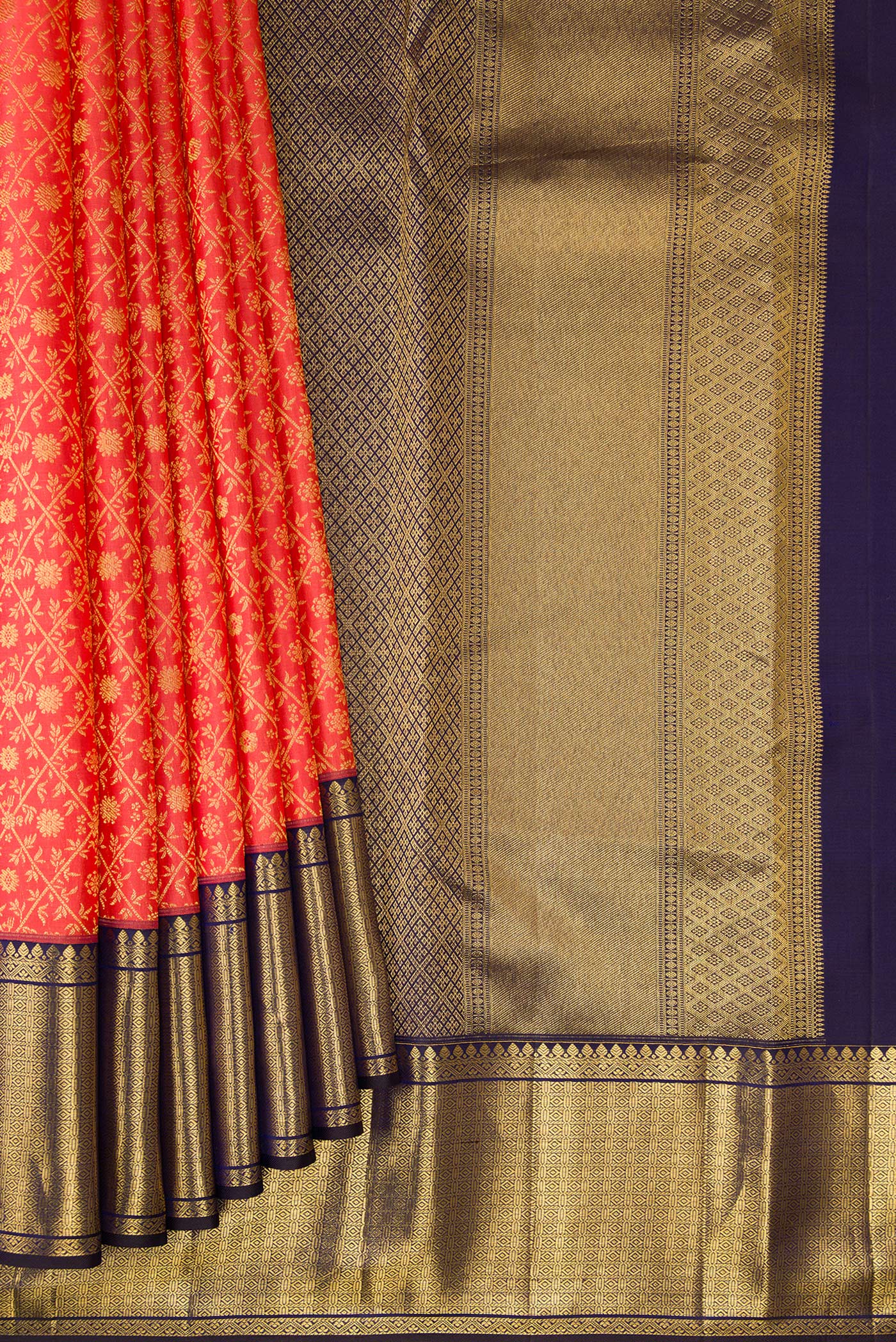Pleats and pallu of Coral Kanchipuram Silk Saree with Zari Brocade on the body and Zari Border. 