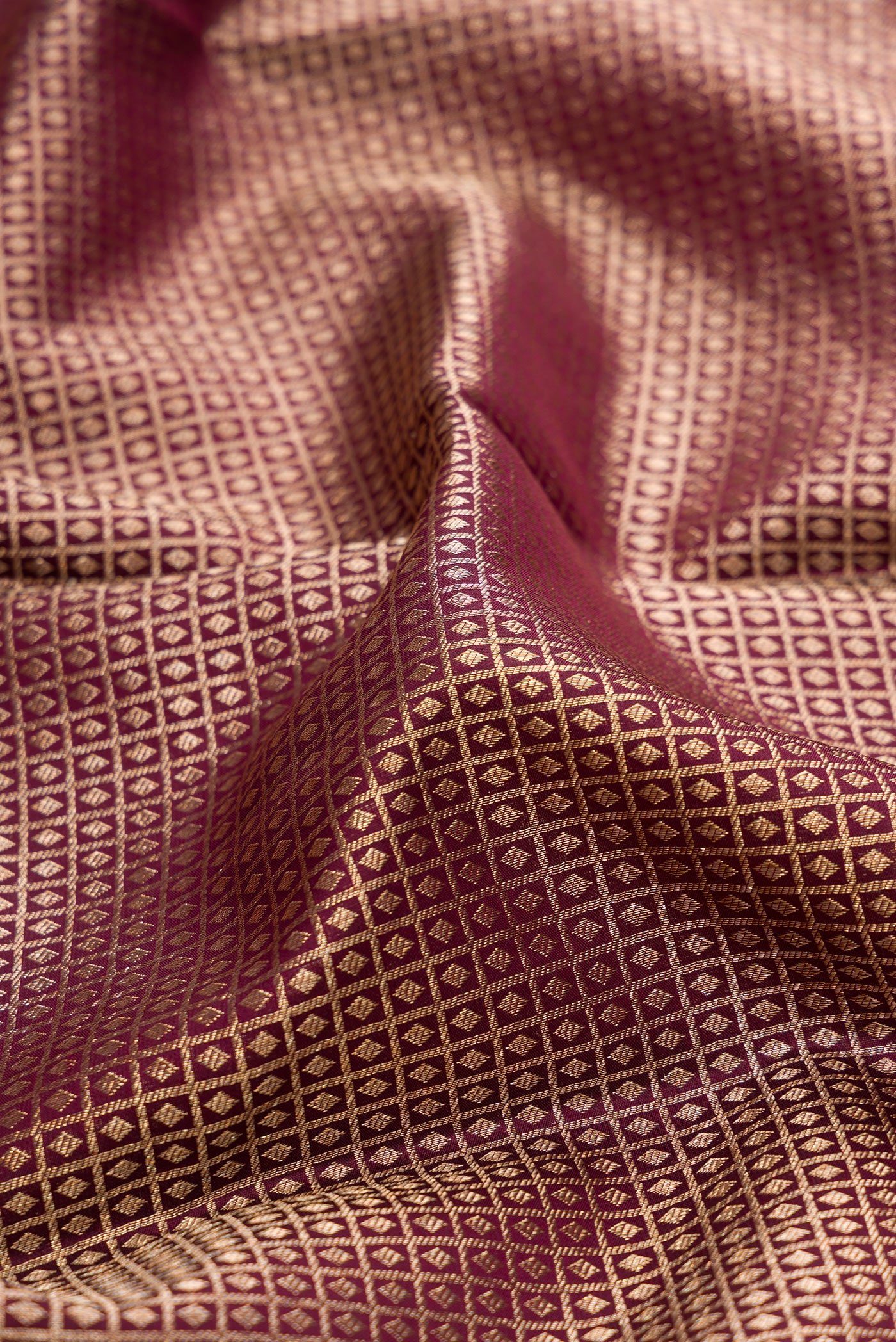 Close up of Coffee Brown Kanchipuram Silk Saree with Zari Brocade on the body and Zari Border.  displaying folds