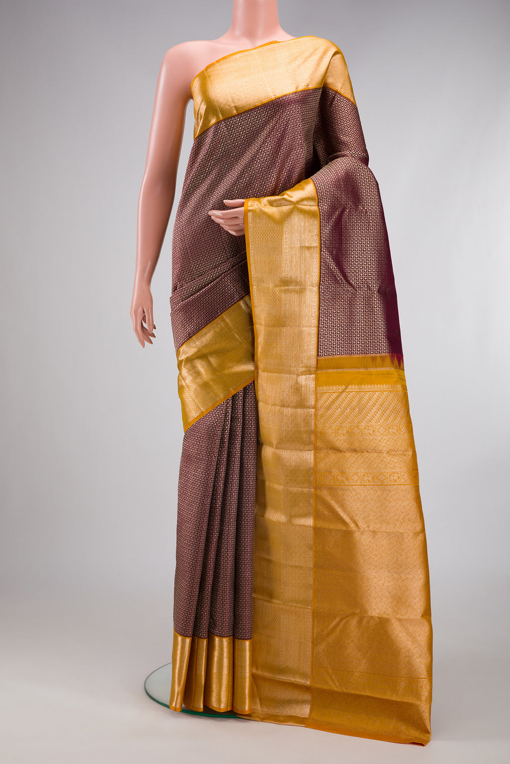 Coffee Brown Kanchipuram Silk Saree with Zari Brocade on the body and Zari Border.  displayed on a mannequin