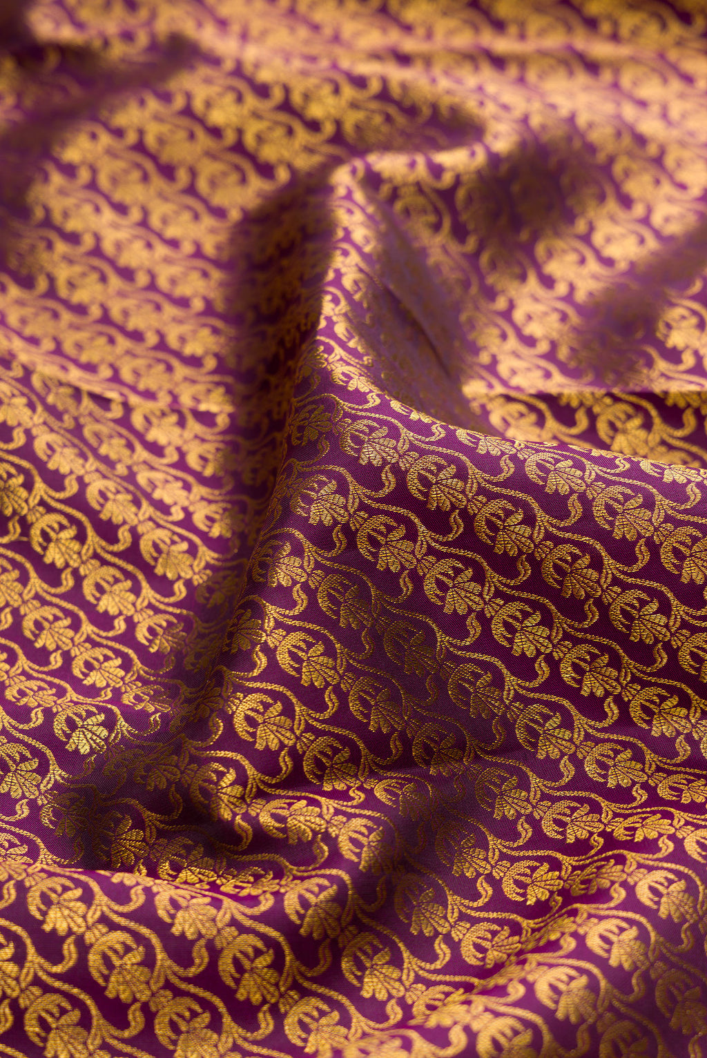 Close up of Burgundy Kanchipuram Silk Saree with Zari Brocade on the body and Fancy Border.  displaying folds