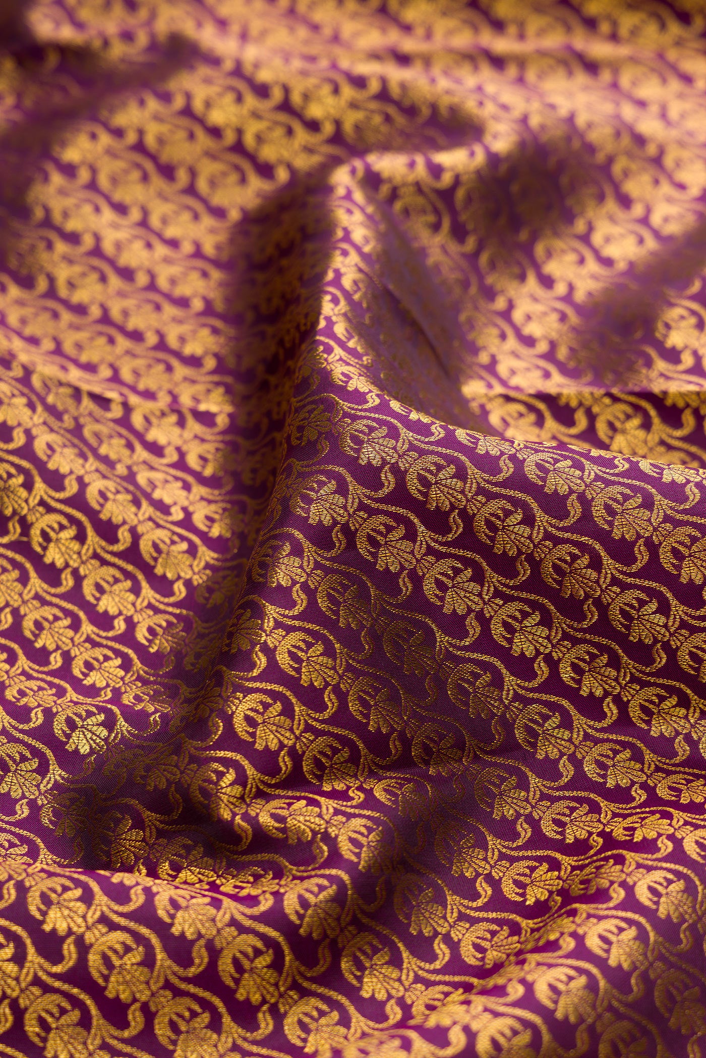 Close up of Burgundy Kanchipuram Silk Saree with Zari Brocade on the body and Fancy Border.  displaying folds