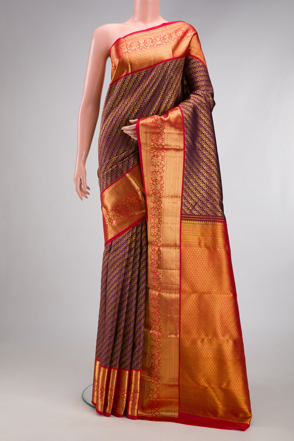 Burgundy Kanchipuram Silk Saree with Zari Brocade on the body and Fancy Border.  displayed on a mannequin