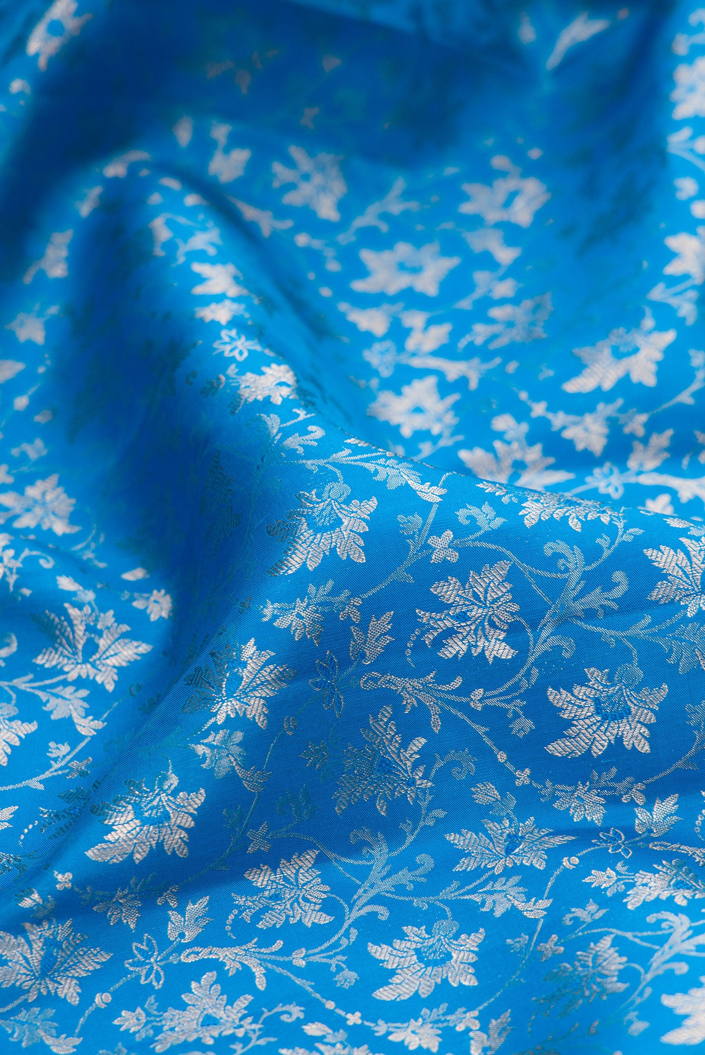 Close up of Blue Kanchipuram Silk Saree with Zari Brocade on the body and Zari Border.  displaying folds