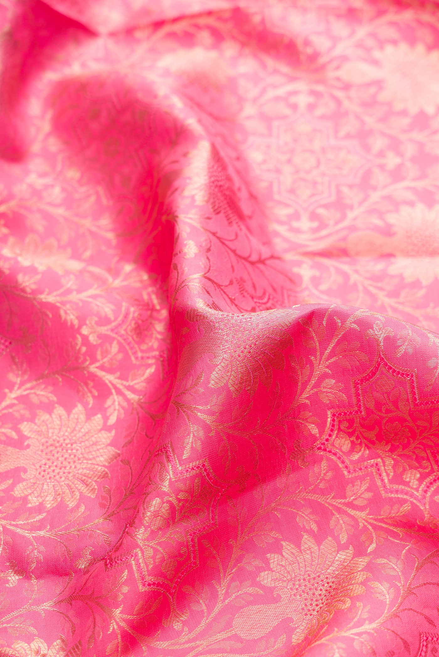 Close up of Pink Kanchipuram Silk Saree with Zari Brocade on the body and Zari Border.  displaying folds
