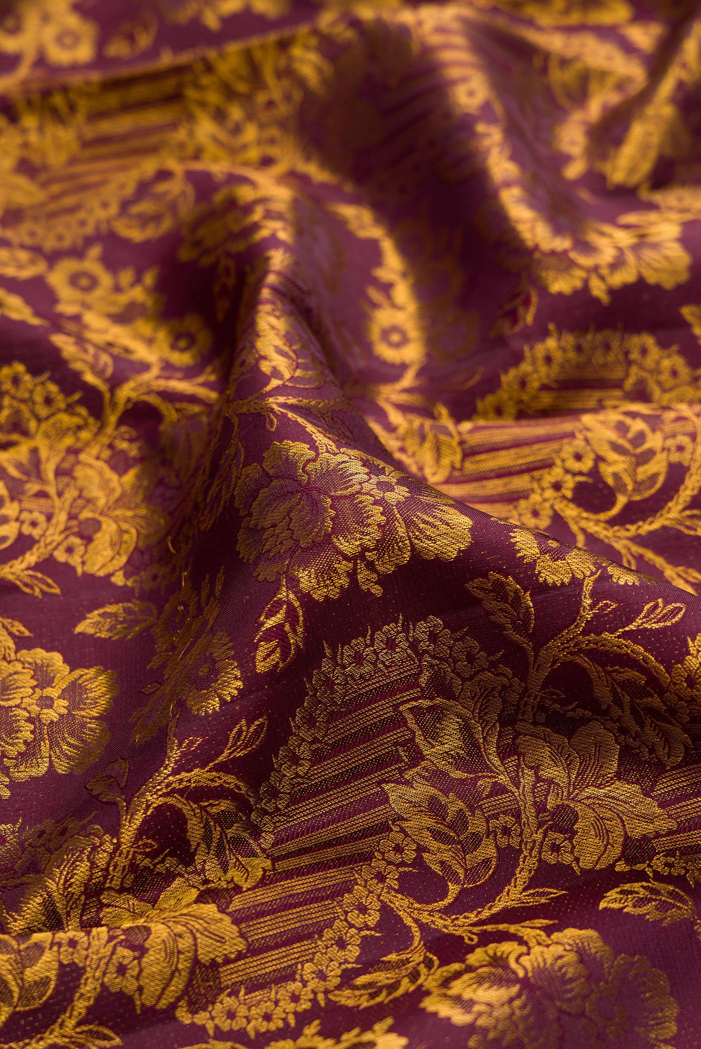 Close up of Coffee Brown Kanchipuram Silk Saree with Zari Brocade on the body and Zari Border.  displaying folds