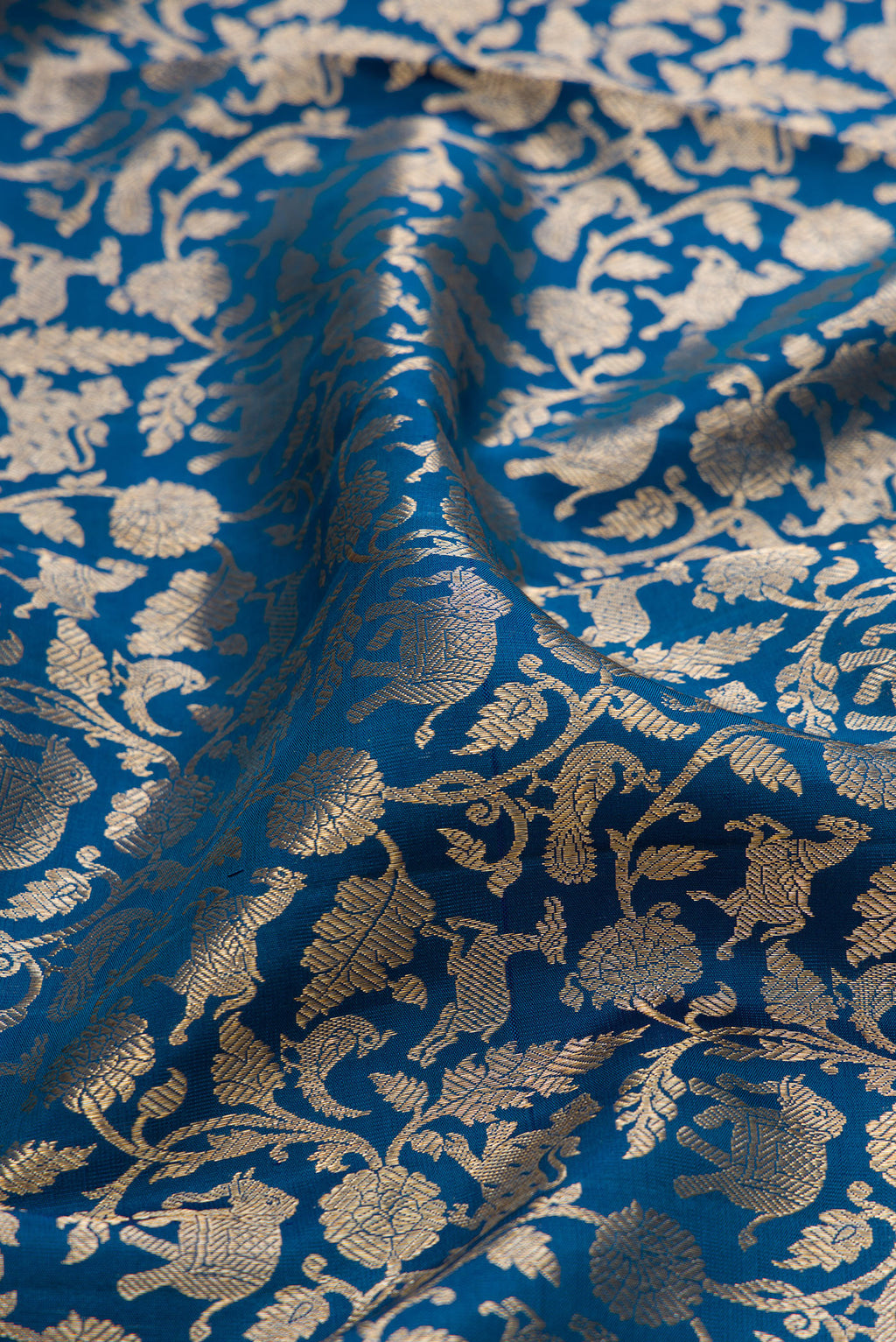 Close up of Peacock Blue Kanchipuram Silk Saree with Zari Brocade on the body and Zari Border.  displaying folds