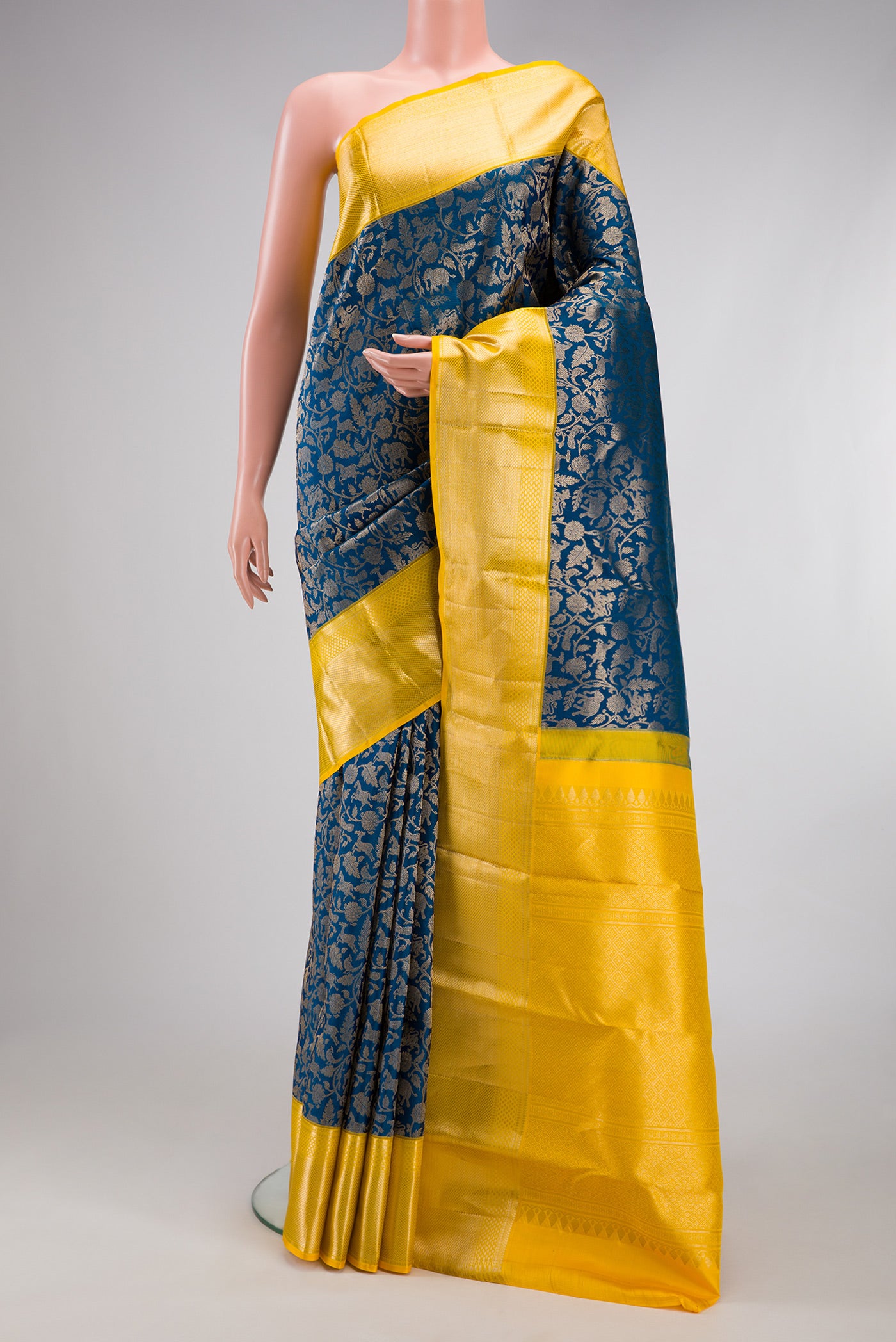 Peacock Blue Kanchipuram Silk Saree with Zari Brocade on the body and Zari Border.  displayed on a mannequin