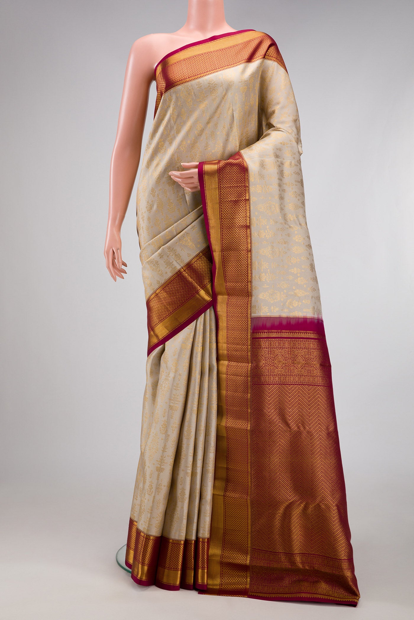 Beige Kanchipuram Silk Saree with Zari Brocade on the body and Zari Border.  displayed on a mannequin