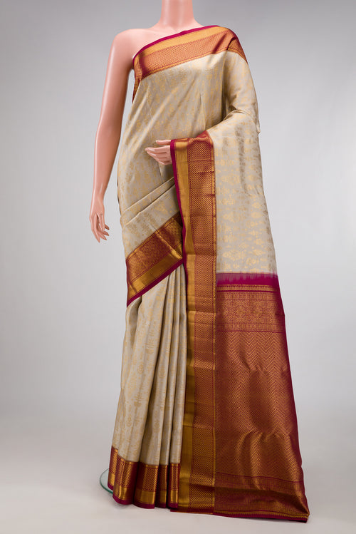 Beige Kanchipuram Silk Saree with Zari Brocade on the body and Zari Border.  displayed on a mannequin
