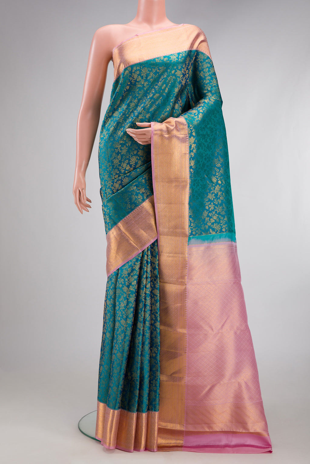 Teal Kanchipuram Silk Saree with Zari Brocade on the body and Zari Border.  displayed on a mannequin