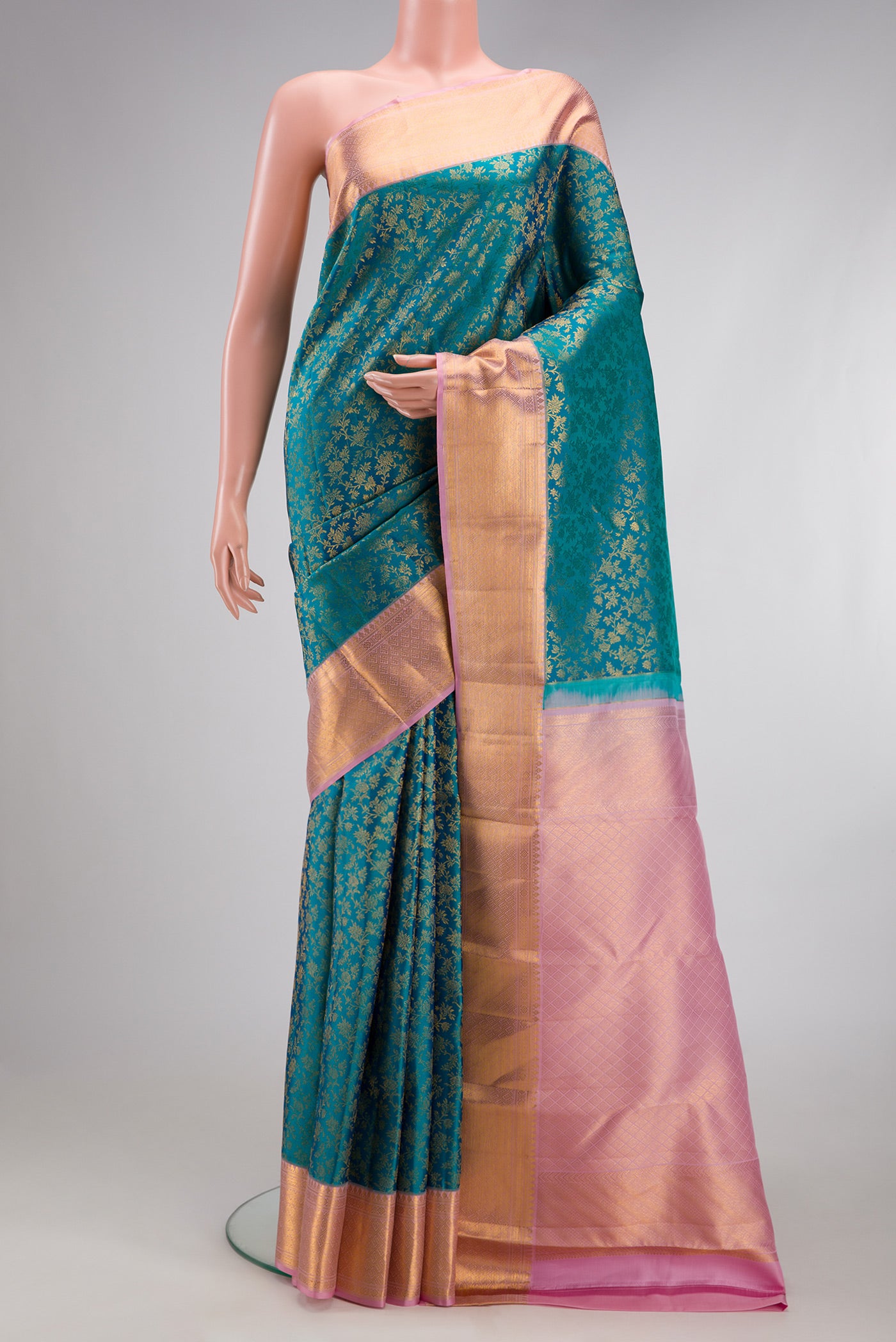 Teal Kanchipuram Silk Saree with Zari Brocade on the body and Zari Border.  displayed on a mannequin